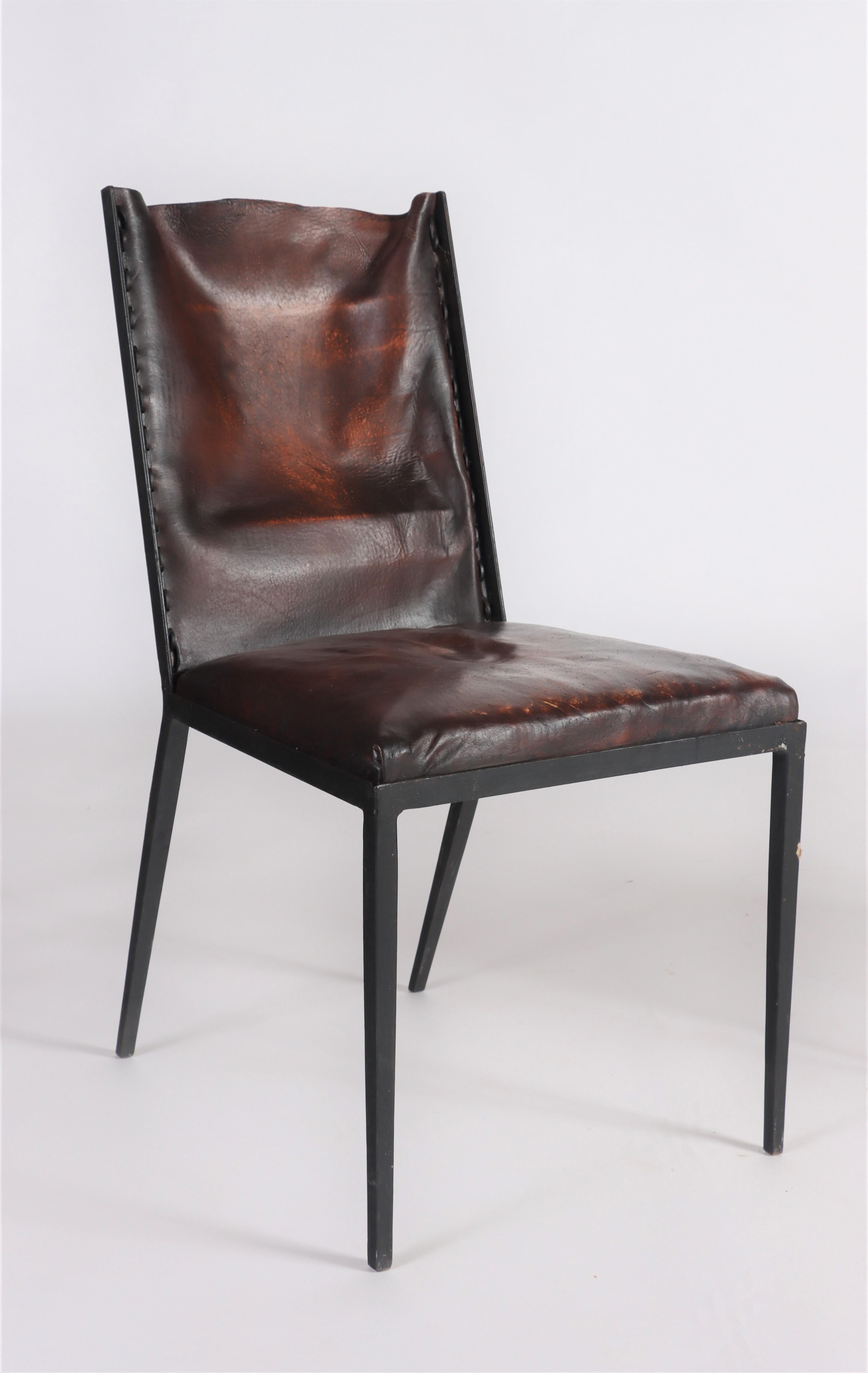 A set of six iron and leather dining chairs, in the manner of Jean-Michel Frank. Contemporary.