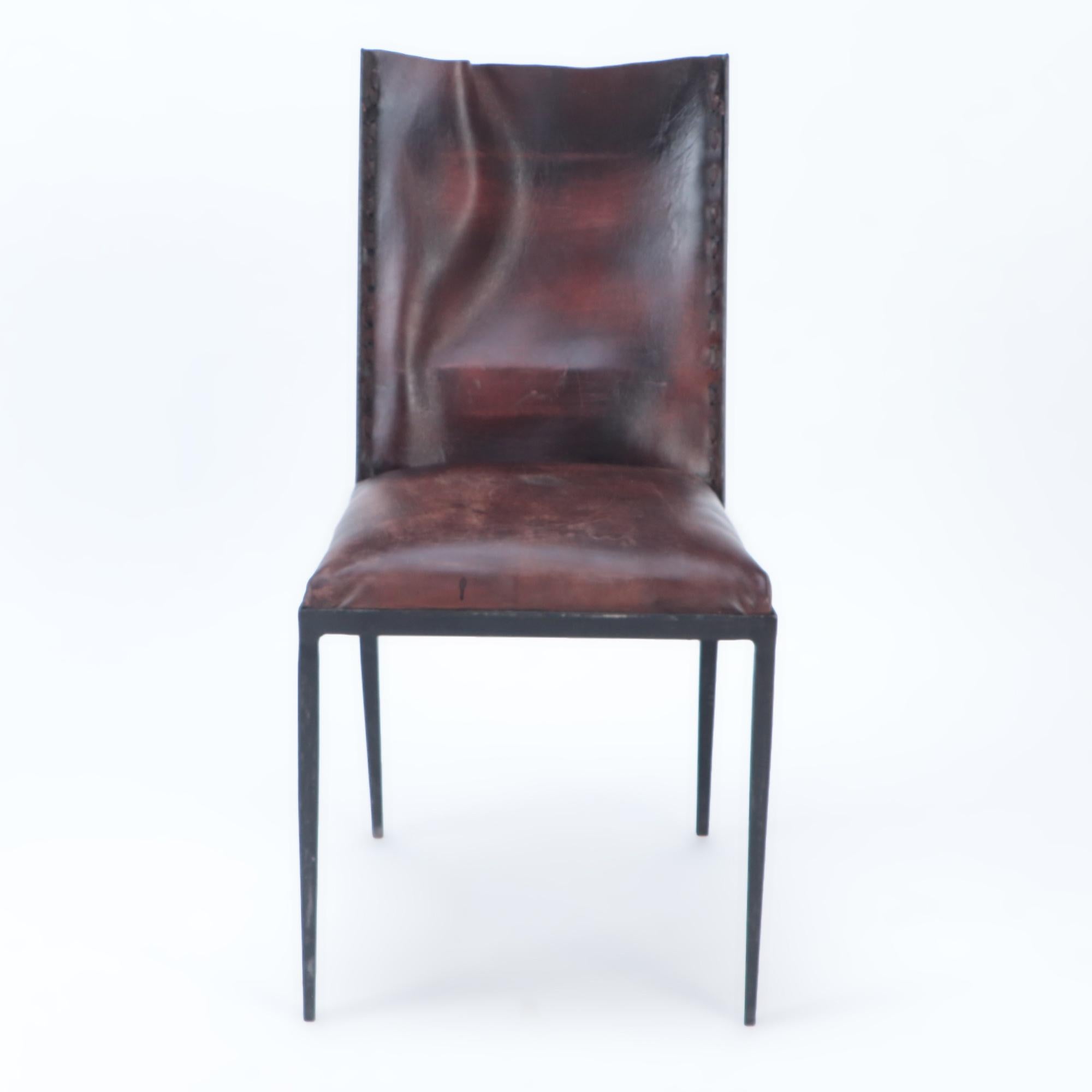 A set of six iron and brown leather dining chairs in the manner of Jean-Michel Frank. Contemporary.
Sold individually as well.