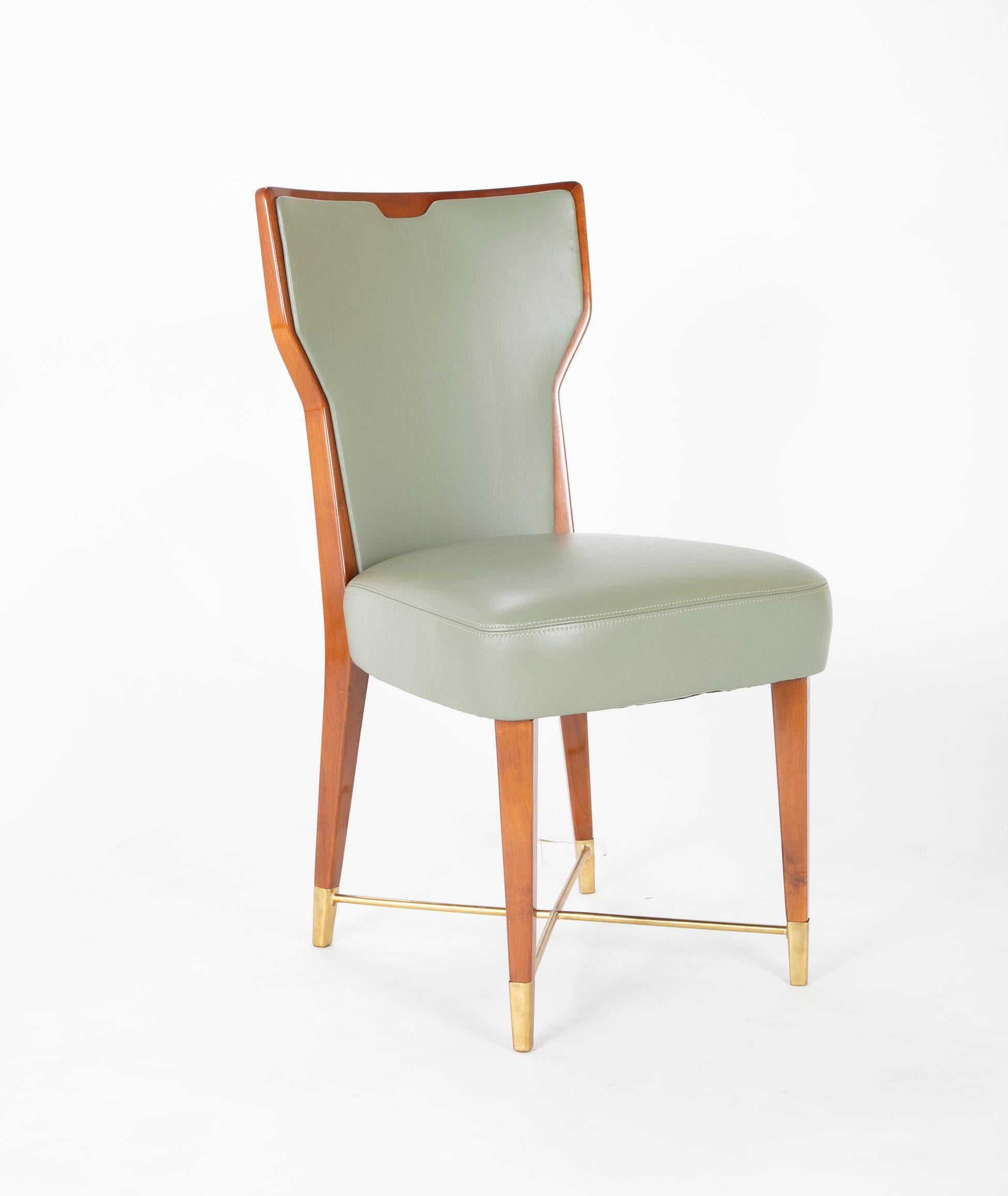 Giorgio Ramponi designed dining chairs. Leather covered mahogany with brass stretcher in a satin finish. 

Literature- A similar model can be seen in Domus, July-August 1950, no. 248-49, back cover.