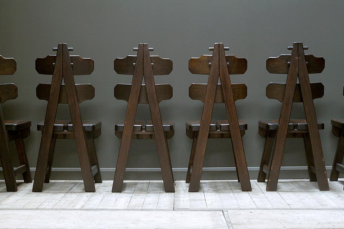 A set of 6 impressive, iconic brutalist chairs, Spain, 1970s. Made of solid oak, these chairs are substantial in weight and striking in appearance. The chairs are also exceptionally comfortable due to the shape of the seat which curves to fit the