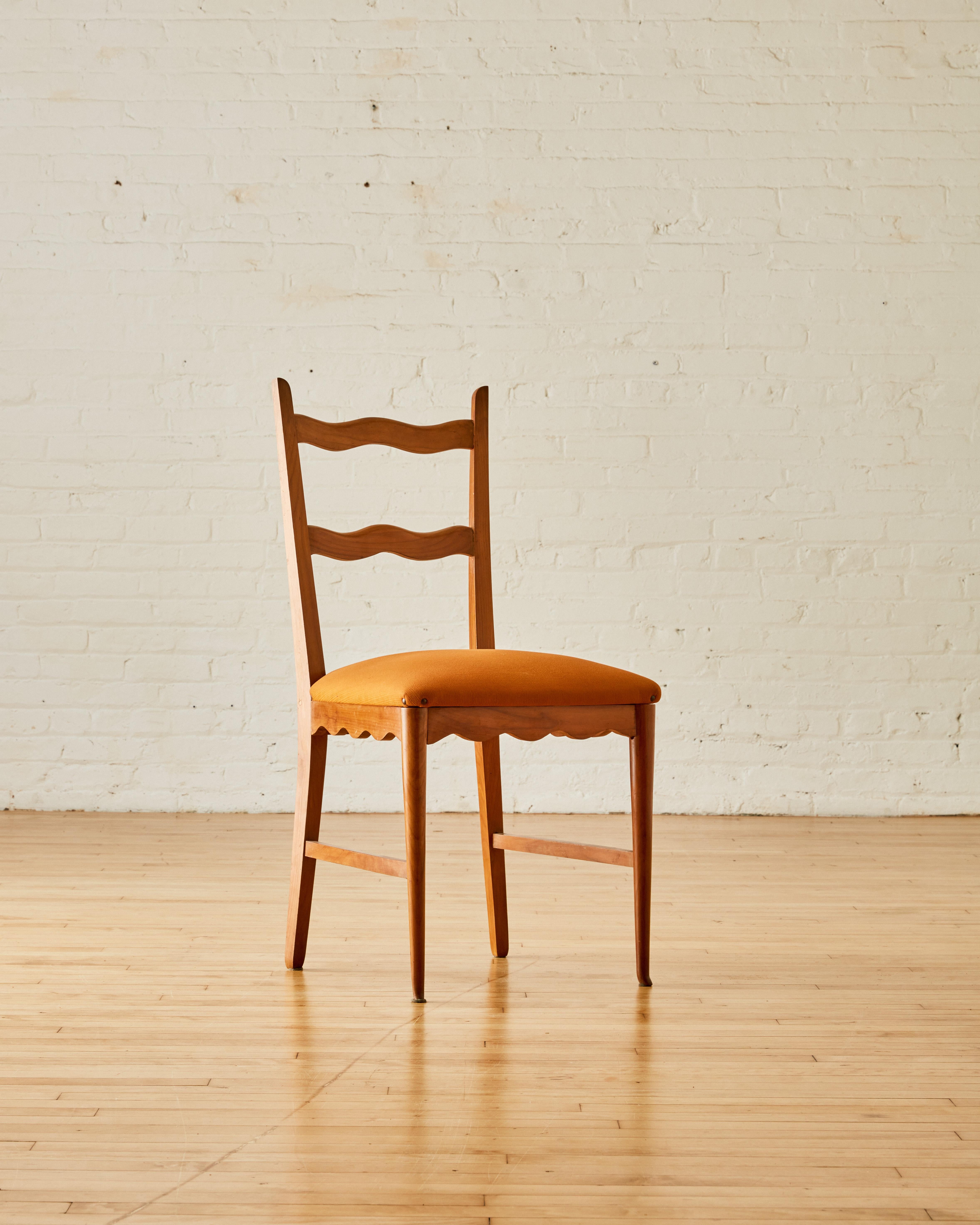 A set of six scalloped dining chairs attributed to Paolo Buffa with a scalloped backrest and seat with original upholstery.

