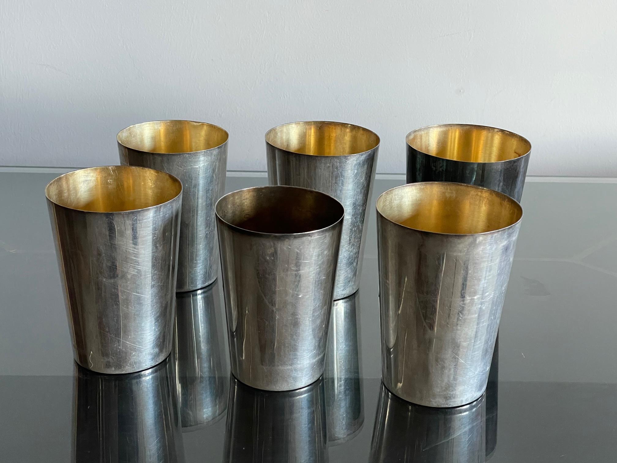 An elegant set of six tumblers retailed by Davis, 200 Picadilly, London. Silverplated brass, all fit in one with original leather holder. Each one marked on bottom with proper hallmarks, made in England.