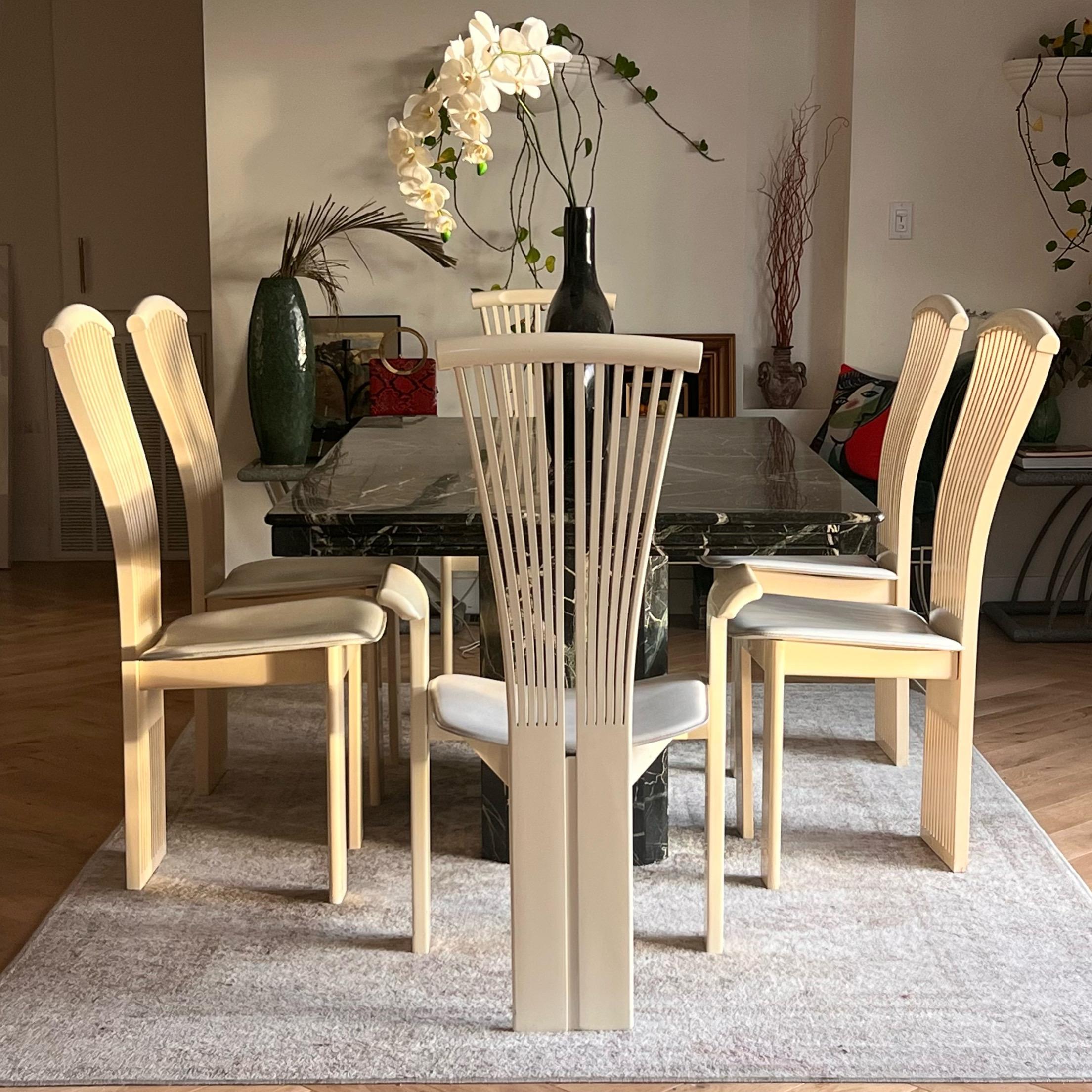 A set of six vintage Italian dining chairs after Pietro Costantini or Torstein Nilsen for Westnofa, mid to late 20th century. Featuring cream lacquered frames with white leather seats, and the classically Italian postmodern “fanned” backs. Some