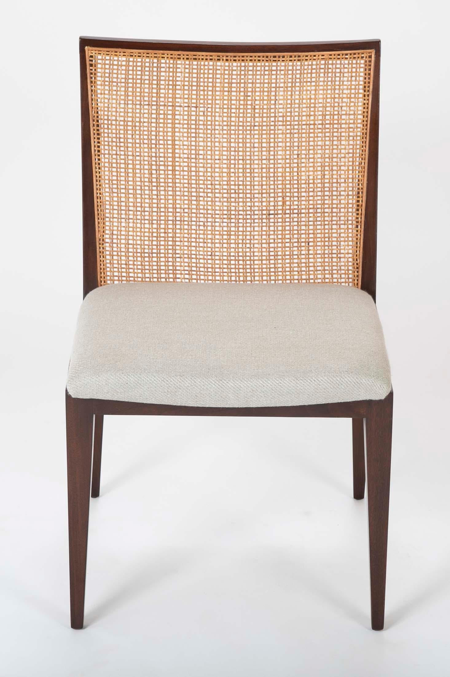 Set of Six Walnut and cane dining chairs by Edward Wormley for Dunbar.  Four of the six chairs retain their original Dunbar lables. Now upholstered in Rogers & Goffigon Fabric with newly caned backs.