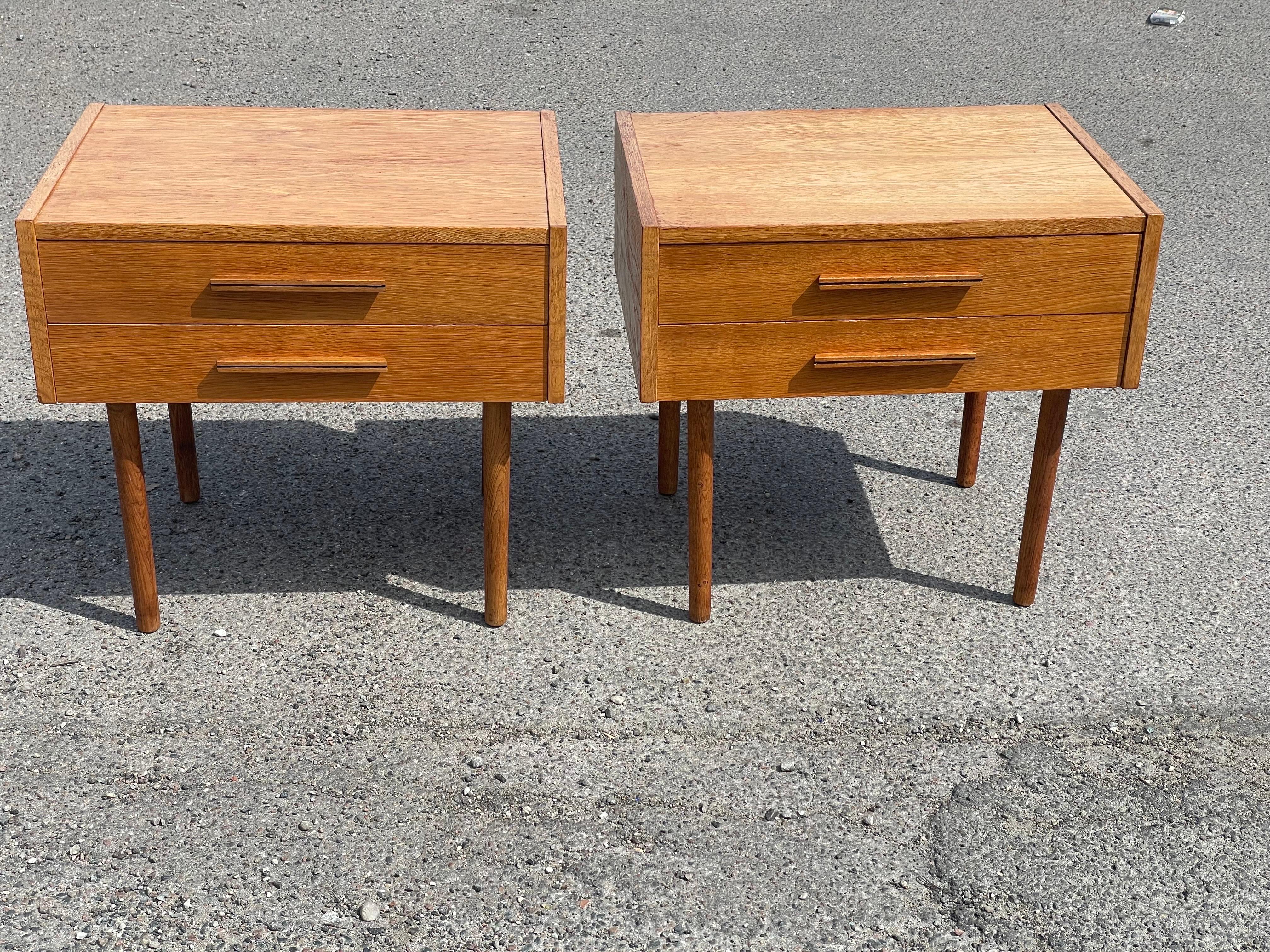 The perfect blend of style and functionality with these two spacious Danish Mid-Century Modern nightstands. Crafted in oak, these nightstands feature a sleek design with clean lines. Each nightstand comes with two drawers, providing ample storage