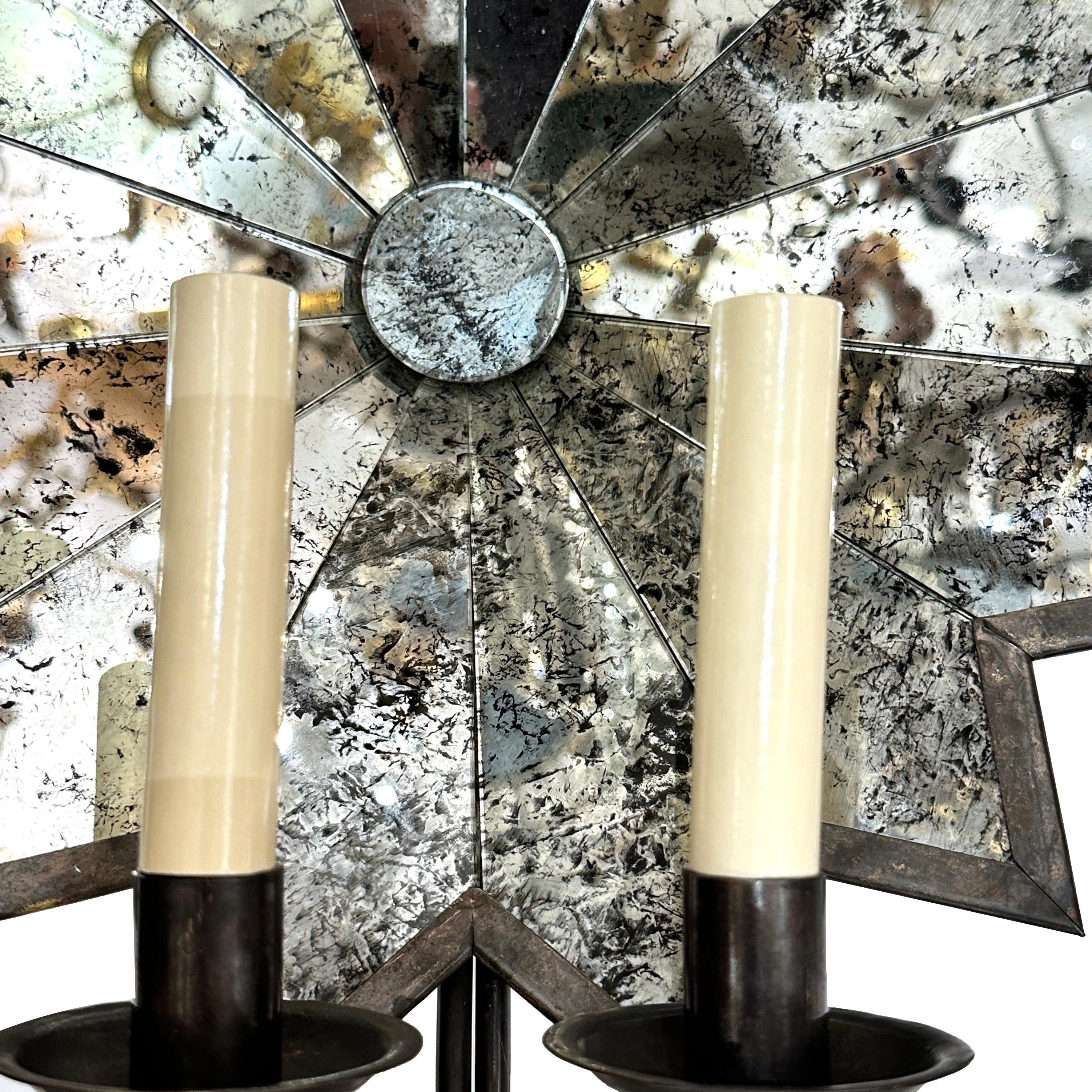 A set of circa 1950's French mirrored sconces with 2 lights. Sold per pair.

Measurements:
Height: 17