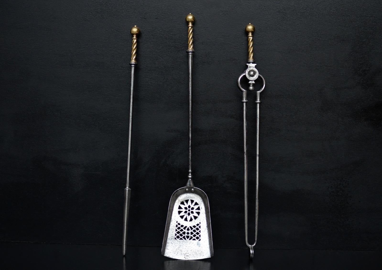 A set of steel firetools with brass barley twist pattern tops, pierced shovel. Circa 1880.

Length:	720 mm      	28 ⅜