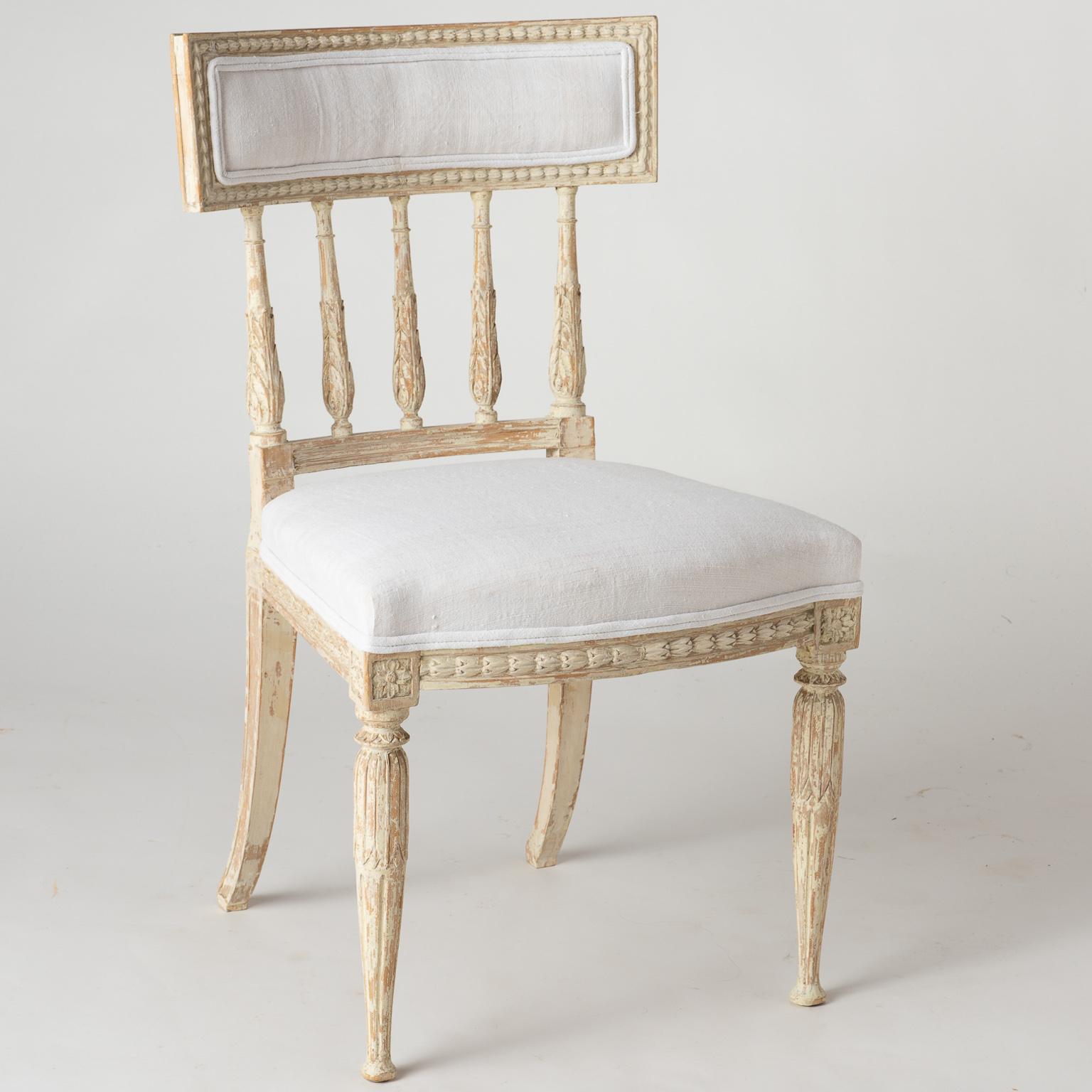 The backs on these elegant set of Gustavian Period chairs have spindles decorated with acanthus leaves, that end in a curved upholstered backrest. The acanthus motif is echoed on the legs as well. Chairs, such as these, are so comfortable that they