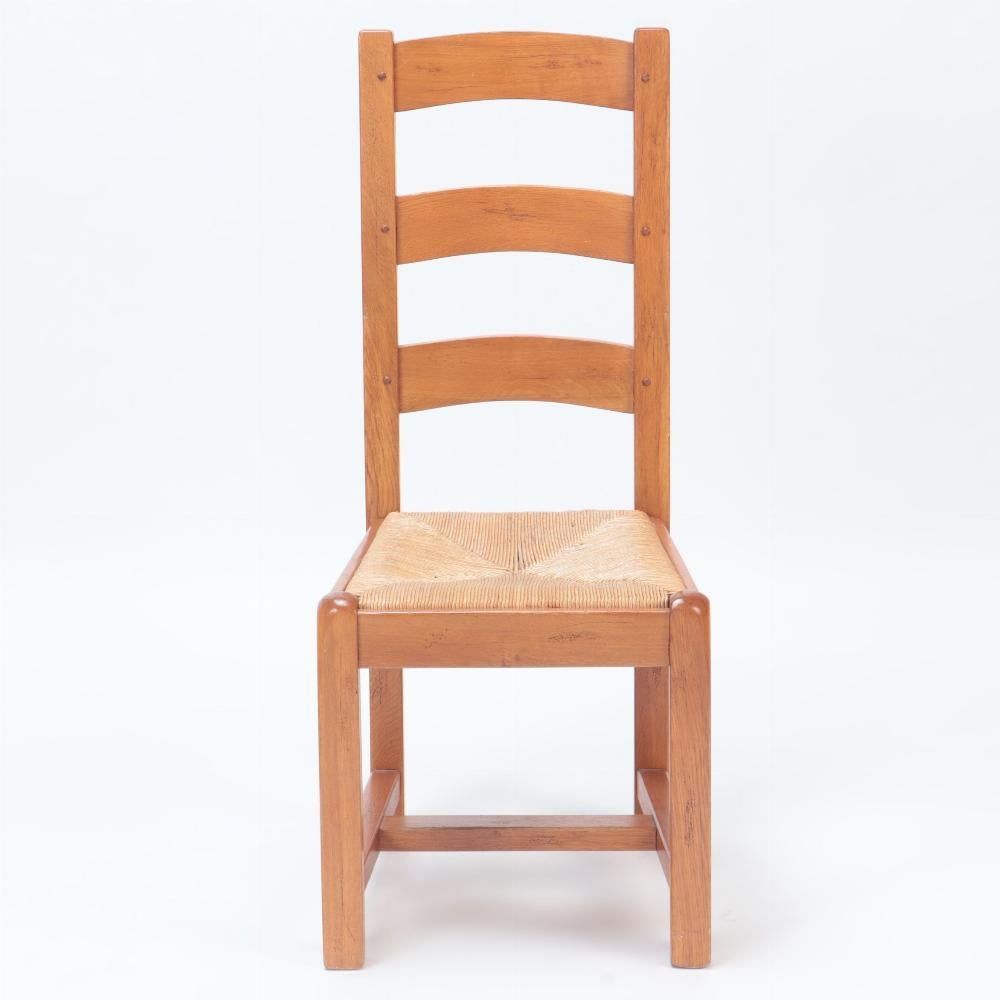 Rush A set of ten French oak ladderback side chairs, C. 1960. For Sale