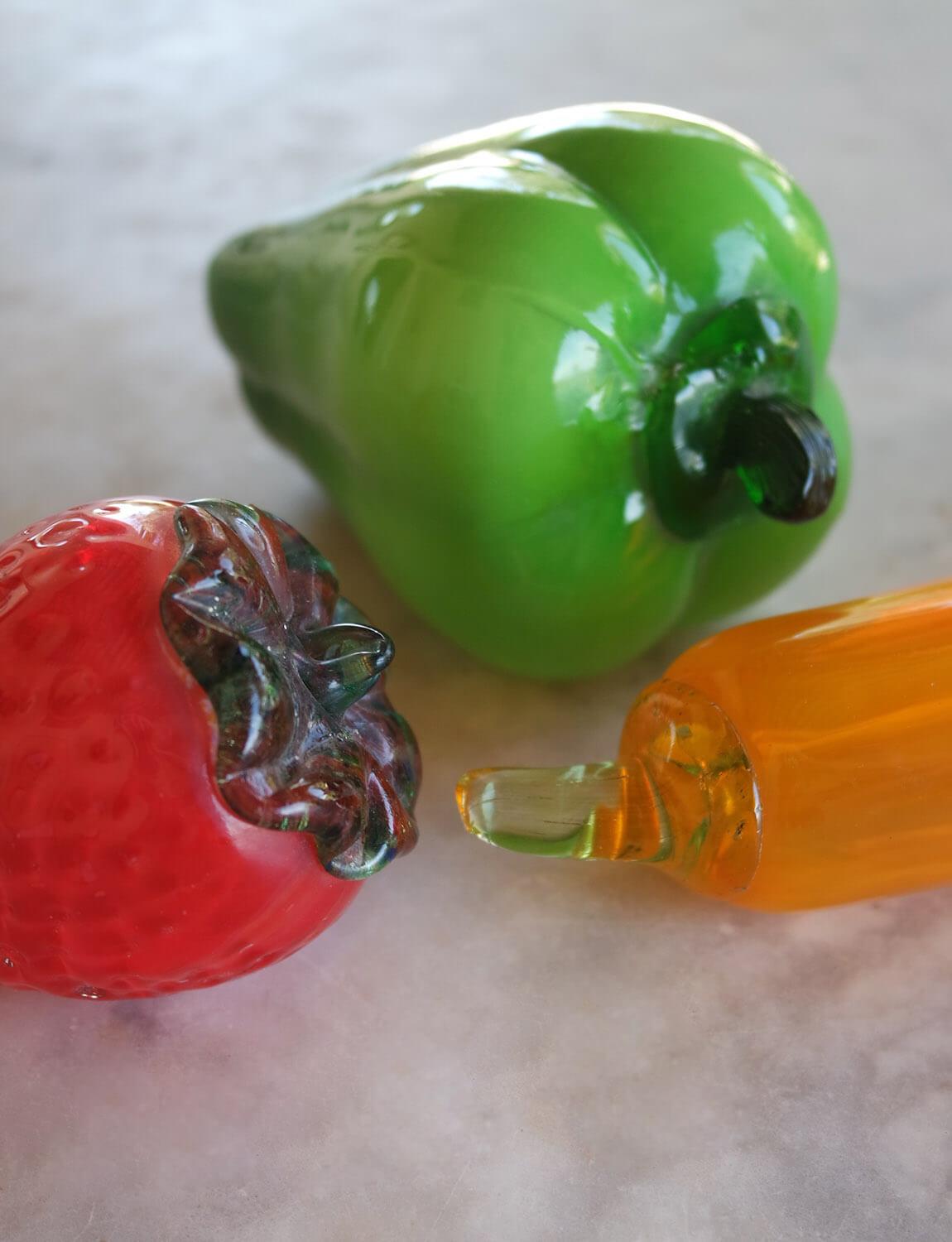 Beautiful hand-blown hollow fruit set with Green pepper, strawberry and banana. These vibrant glass pieces look beautiful sitting in a bowl on a kitchen table.