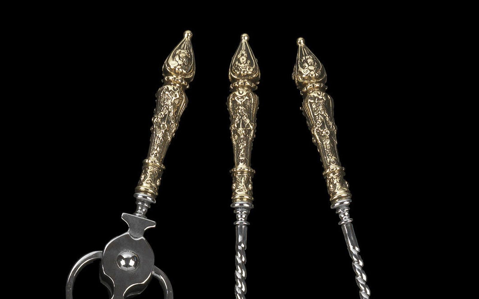 With elaborate foliate and scrolled brass finial handles with scrolling stems.