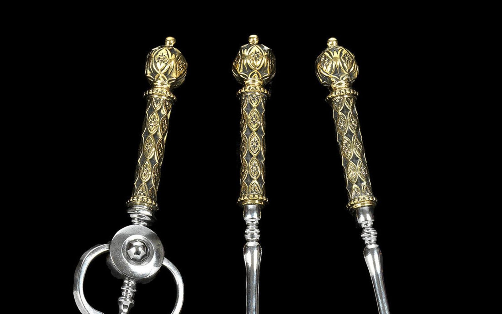 With elaborate brass knob handles and plain steel stems.