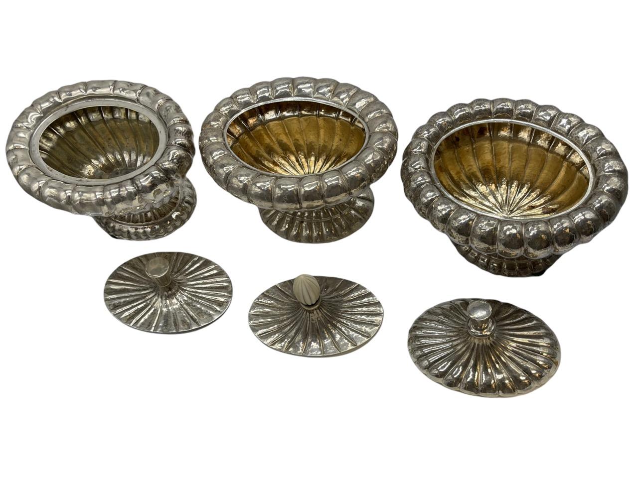 A set of three Austrian silver boxes and covers, Johann Hoppe, Vienna, circa 1925. These are marked on bases and covers in Secessionist style, one with ivorine finial and gilt interiors.
 