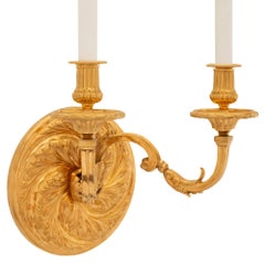 A set of three French 19th century Regence st. Ormolu sconces
