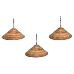 A set of three Italian 1970s pencil reed bamboo and chrome ceiling lights