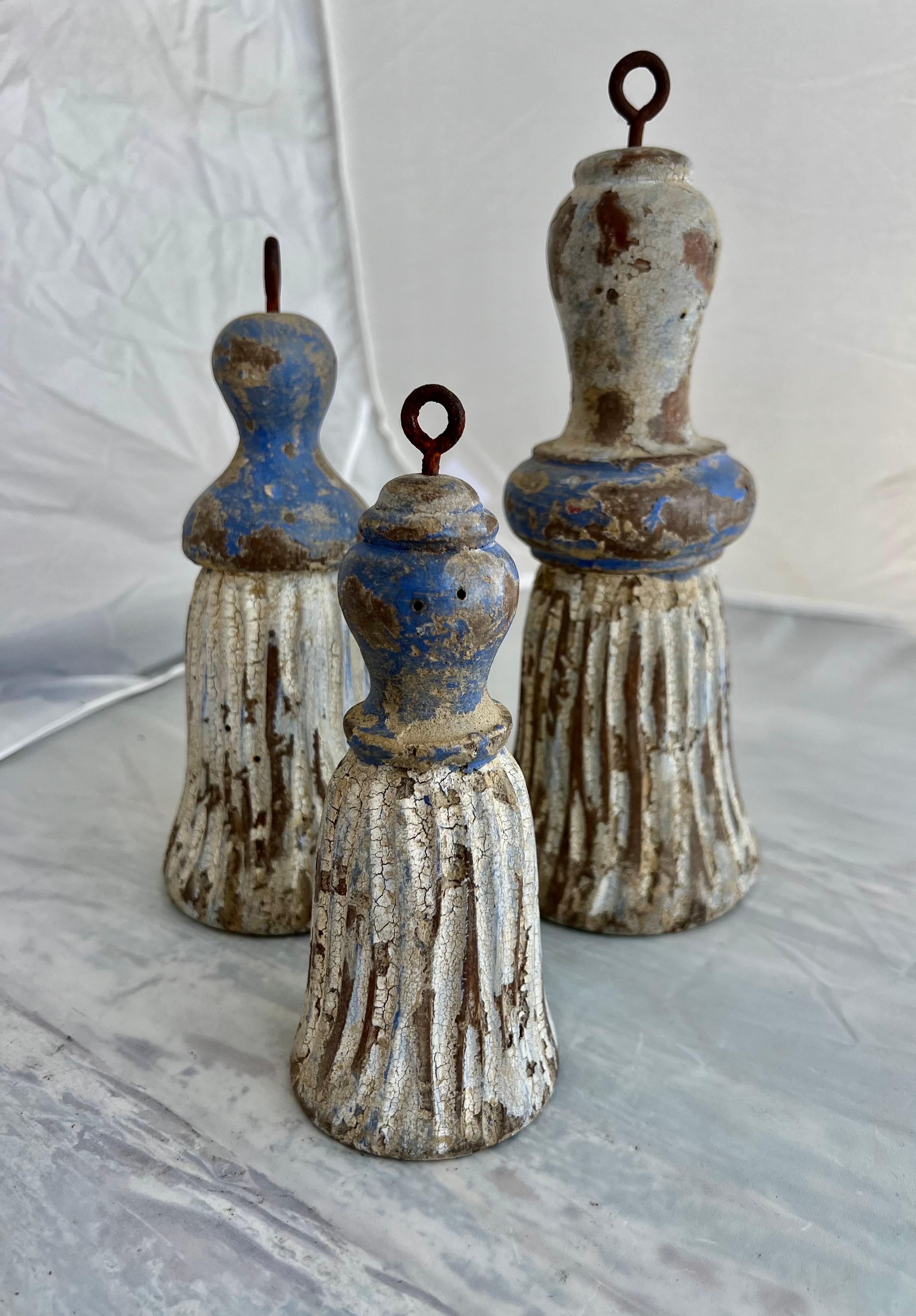 A set of three carved wood & painted tassels from Italy.  Their varying sizes would make them versatile for decorating bookshelves or end tables, adding a touch Italian craftsmanship to your space.

Size of tassels:

1) 4