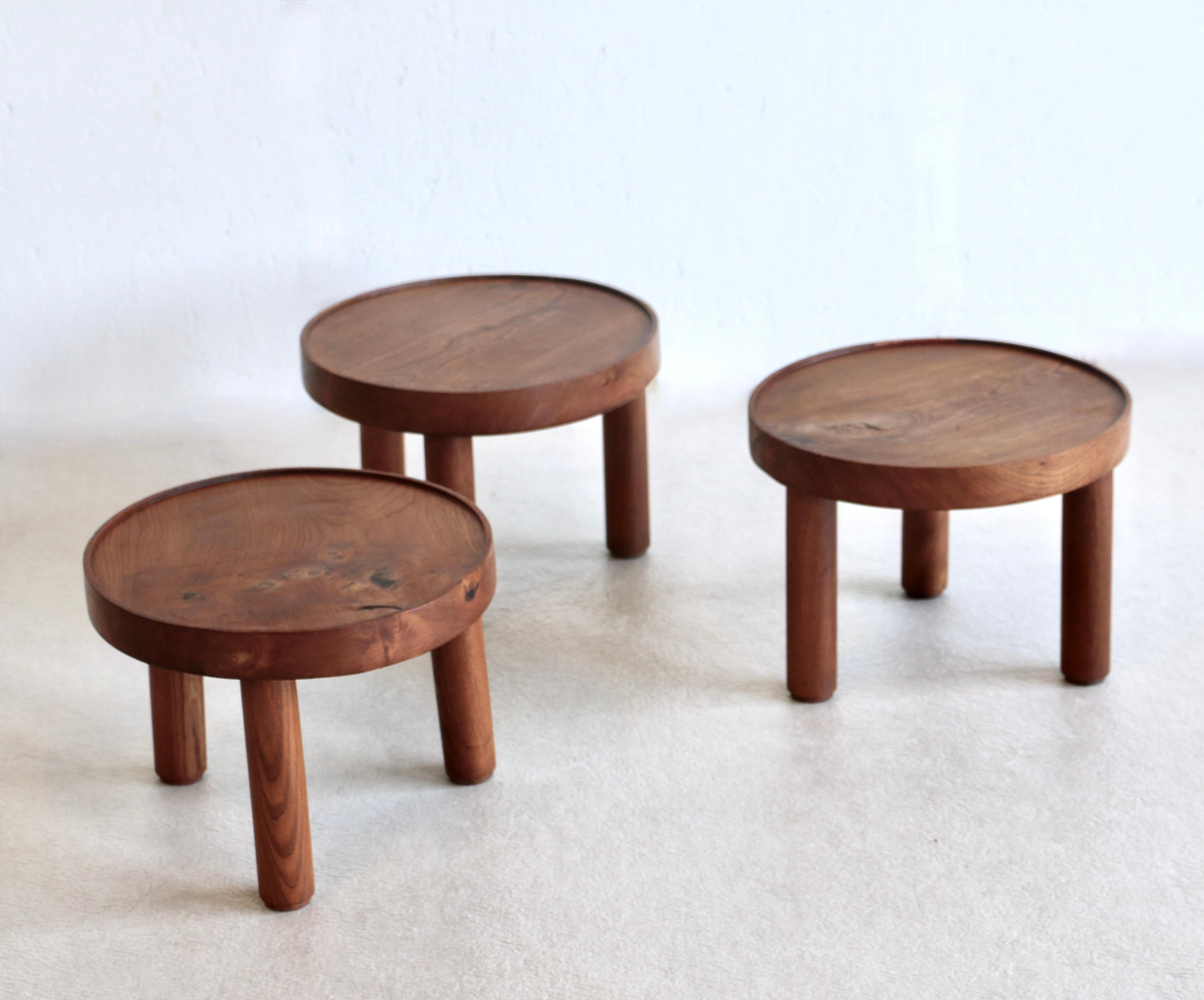 A rare set of three small Japanese-style round tables. A thick circular top in solid ash and three cylindrical legs make up each table.  Mado Jolain and René Legrand for House of Edition France 1956