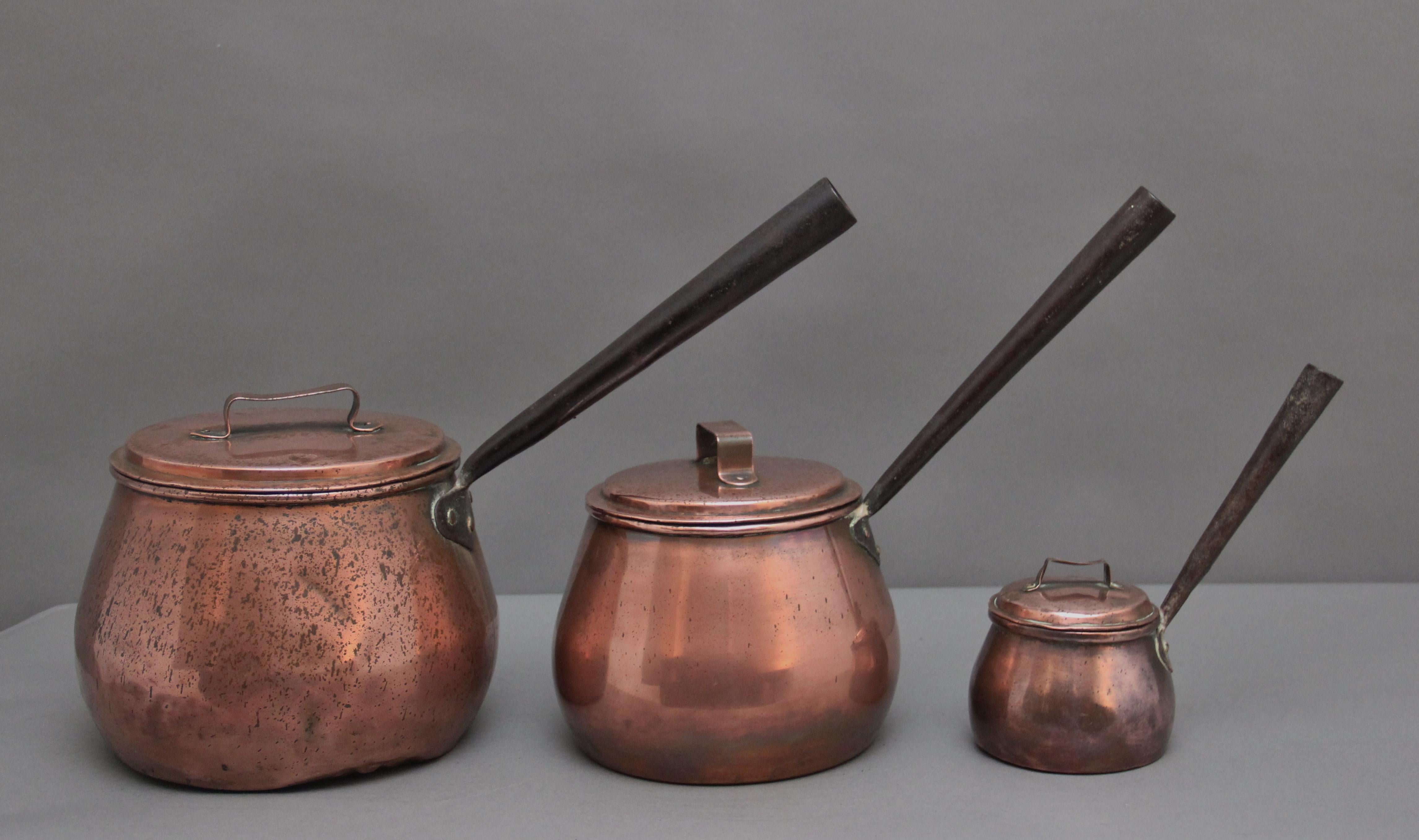 A nice set of three Victorian copper saucepans with long steel handles, each saucepan of circular form and having copper lids with a handle.  Circa 1860.

Large saucepan - 9 1/2