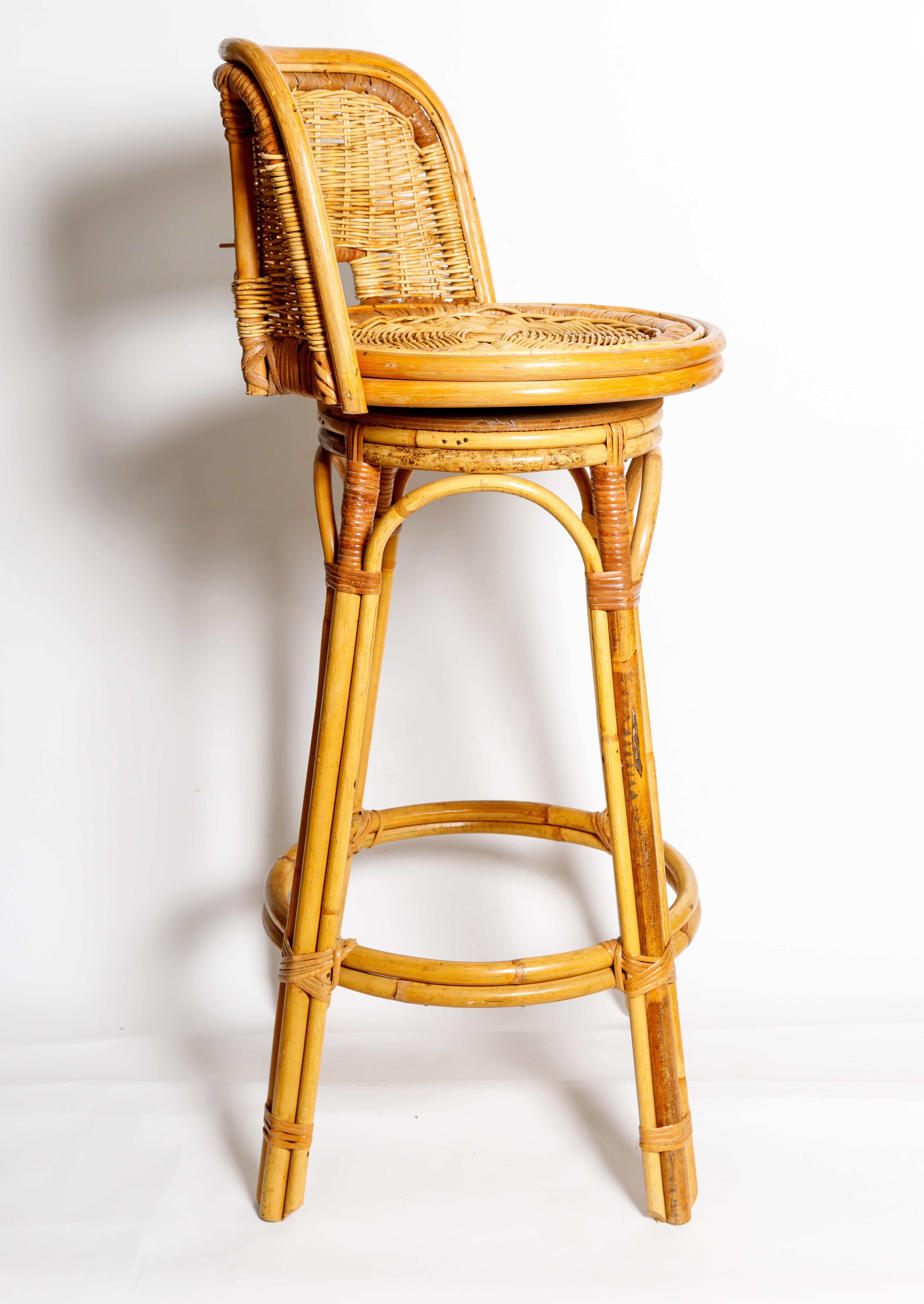 A set of three woven wicker swivel bar stools.