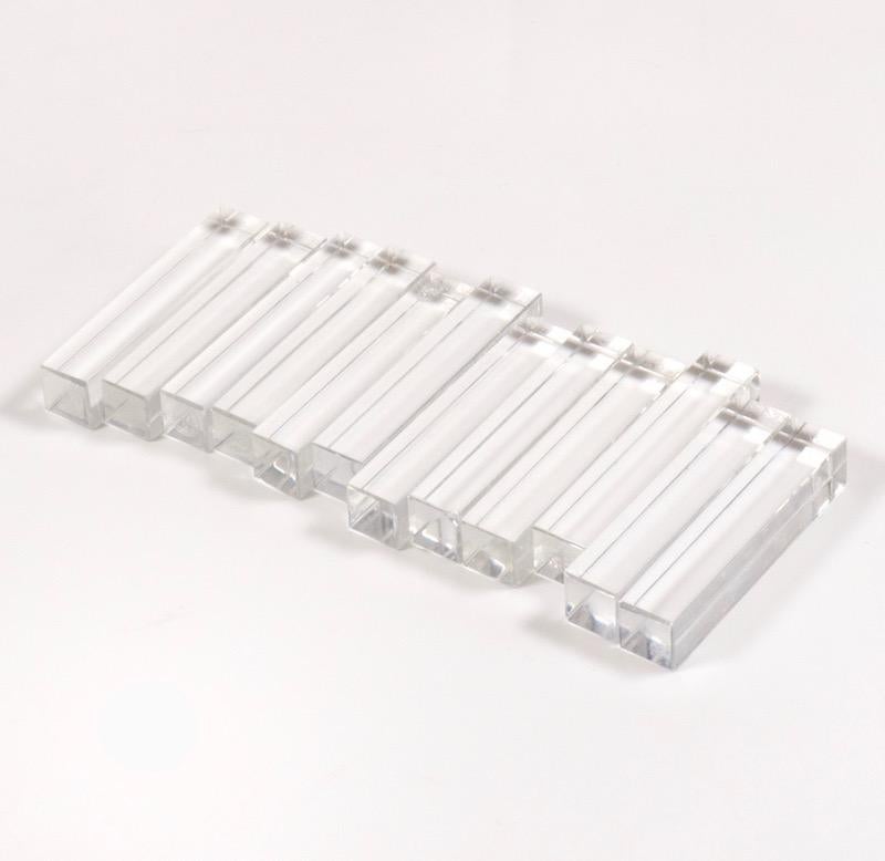 A set of beautifully spare and minimal 1950s “Vega” oblong crystal knife rests, each signed. Set of twelve handcut and bevelled rests in original Baccarat box. Nice bright condition with some light chipping and a little loss to one corner.