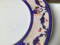 A set of twelve dinner plates by Royal Doulton, a renowned English ceramic mfg.