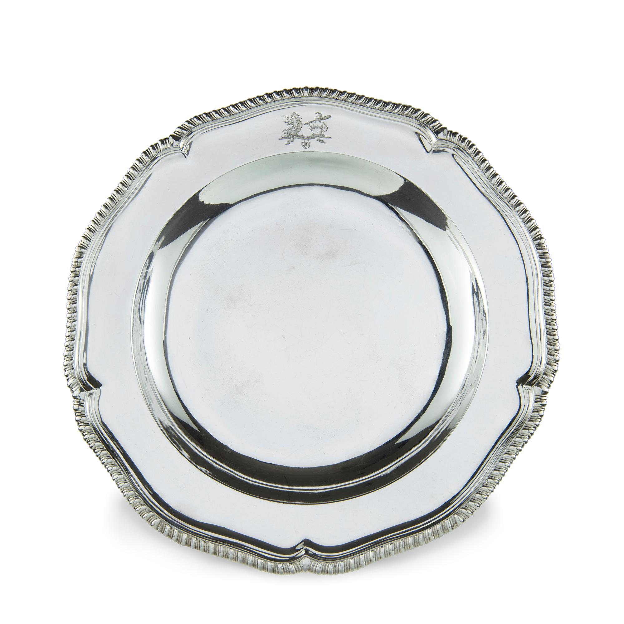 A set of twelve Georgian sterling silver dinner-plates, eleven with the mark of Thomas Heming, London, 1774, one with the mark of Sebastian and James Crespell, London, 1769
Each shaped circular with gadrooned border, later engraved with two crests,