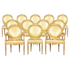 A Set of Twelve Italian Painted Gilt Wood Frame Louis XVI Style Dining Chairs