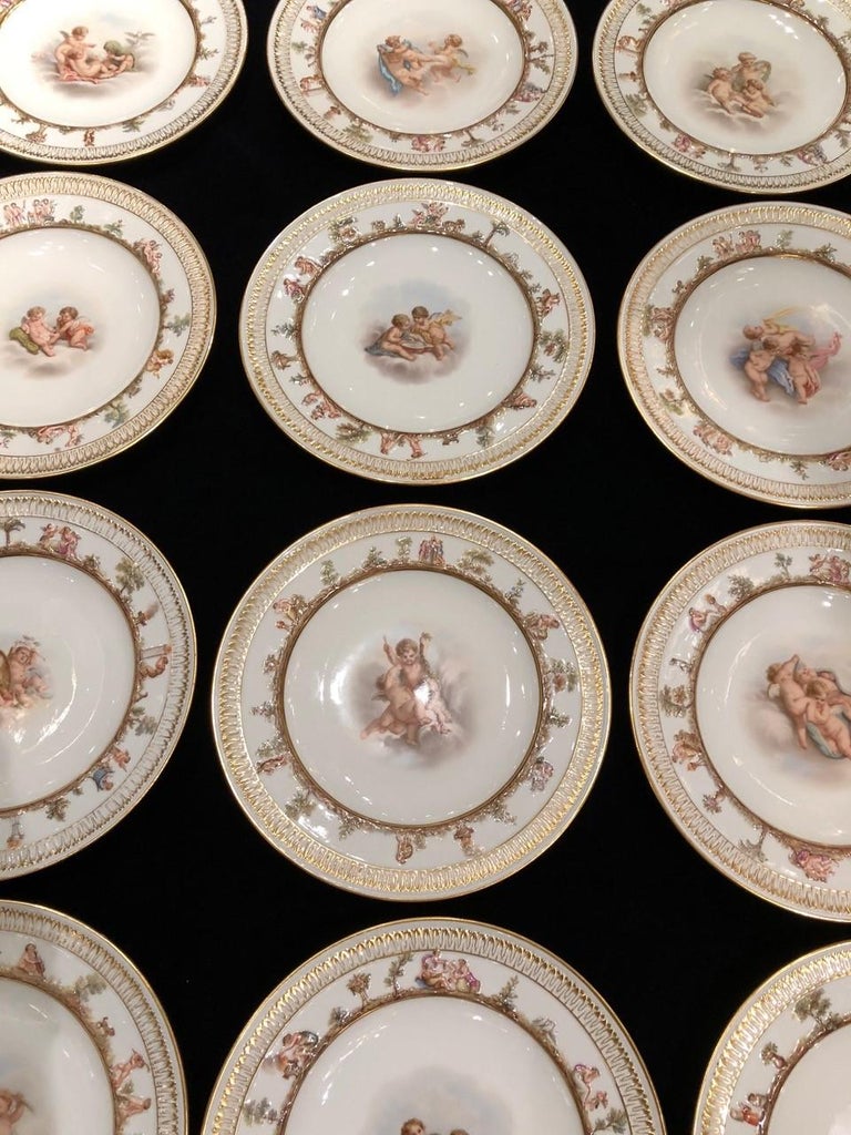 A fabulous and pristine set of twelve neoclassical style 19th century Meissen Porcelain plates hand painted with putti, fruit, garland, and heavenly scenes. The center of each plate is beautifully hand painted with neoclassical scenes of putti's,