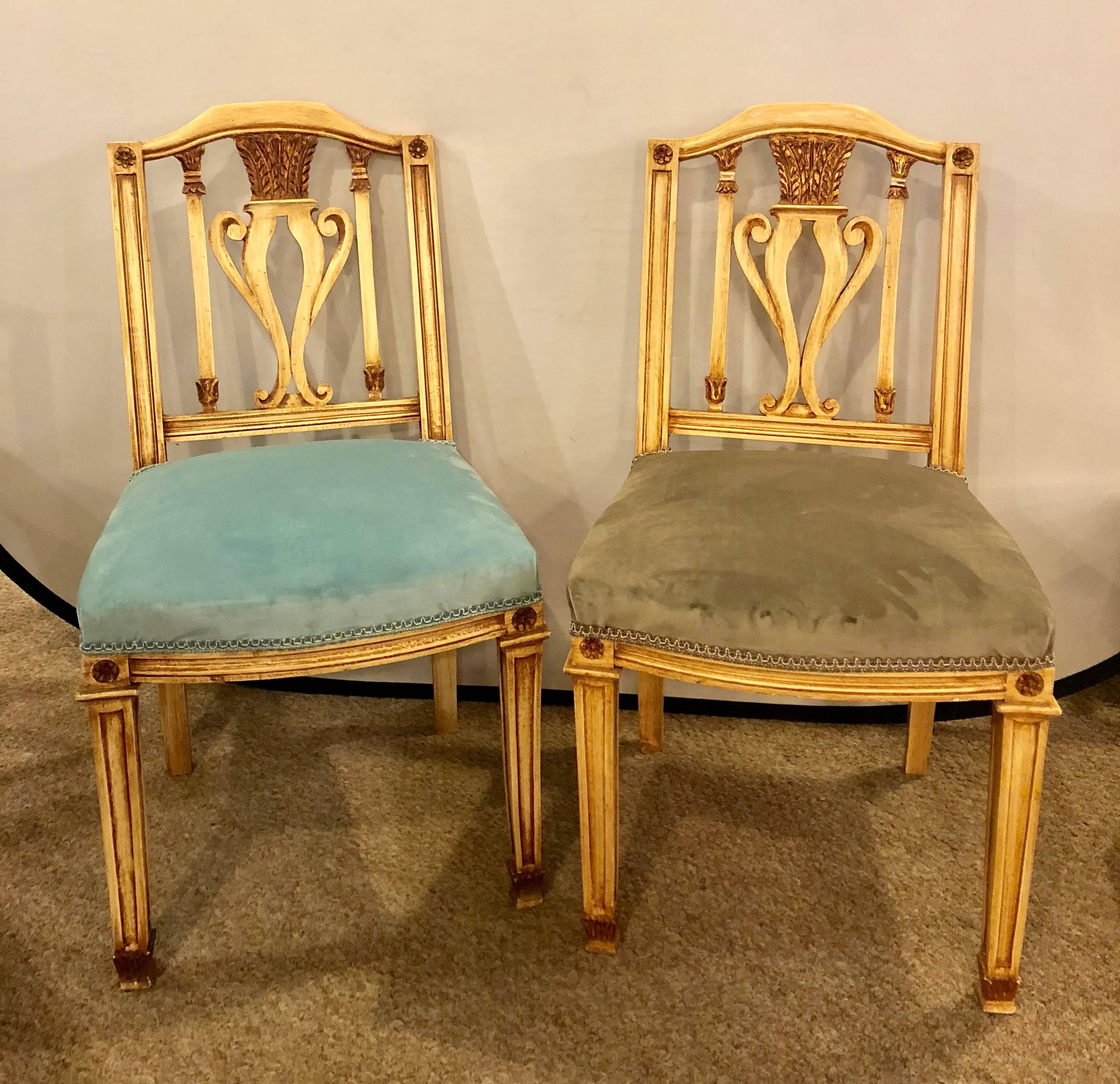 A set of 12 dining chairs comprising seat covers all newly done. 12 Turquoise  painted dining chairs in manner of Maison Jansen. Each of these strong and sturdy dining chairs are finished in a painted and parcel-gilt decorated design with newly