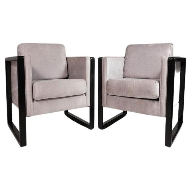 A comfy and spacious set of two cube chairs attributed to Walter Knoll. The ebonized wood from was newly restored and the set was recently upholstered by the party we procured this set from and has light wear consistent with age. This set is stately