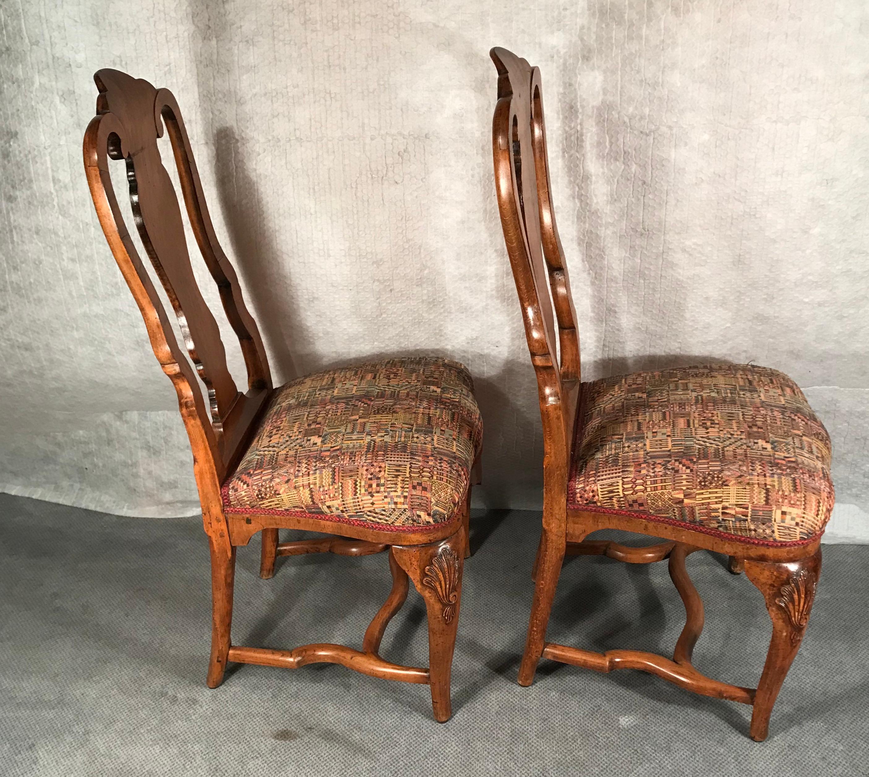 A set of two original Baroque chairs, South German, 18th century.
This unique set of Baroque chairs is made of walnut. The chairs have beautifully carvings on their front legs. They are in good original condition.
They ship from Germany and