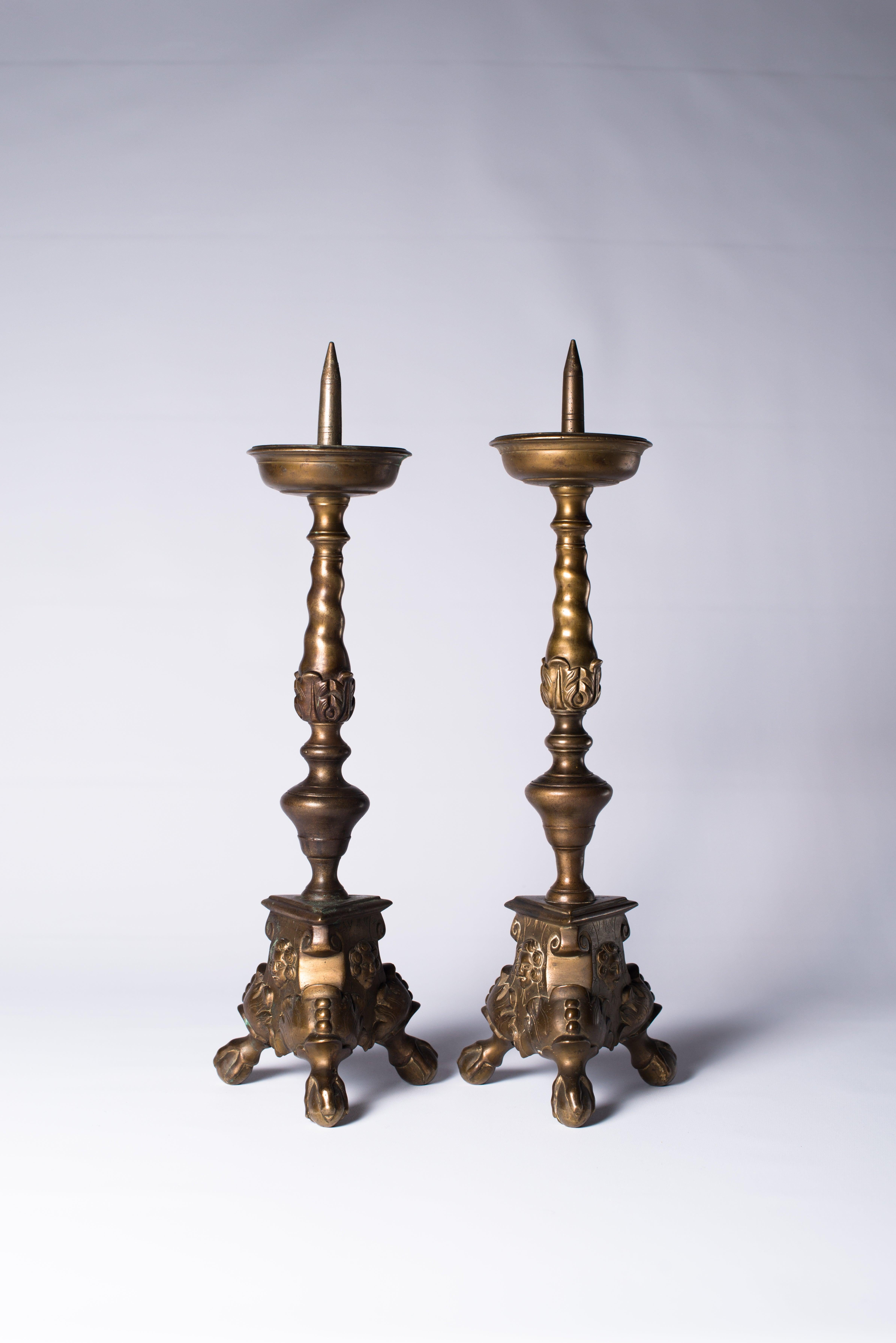 A set of two bronze pricket candlesticks, Southern Netherlands, late 17th century

Description:
A set of two bronze pricket candlesticks, each on shaped triangular base on three ball-and-claw feet, with raised foliate ornaments to base and