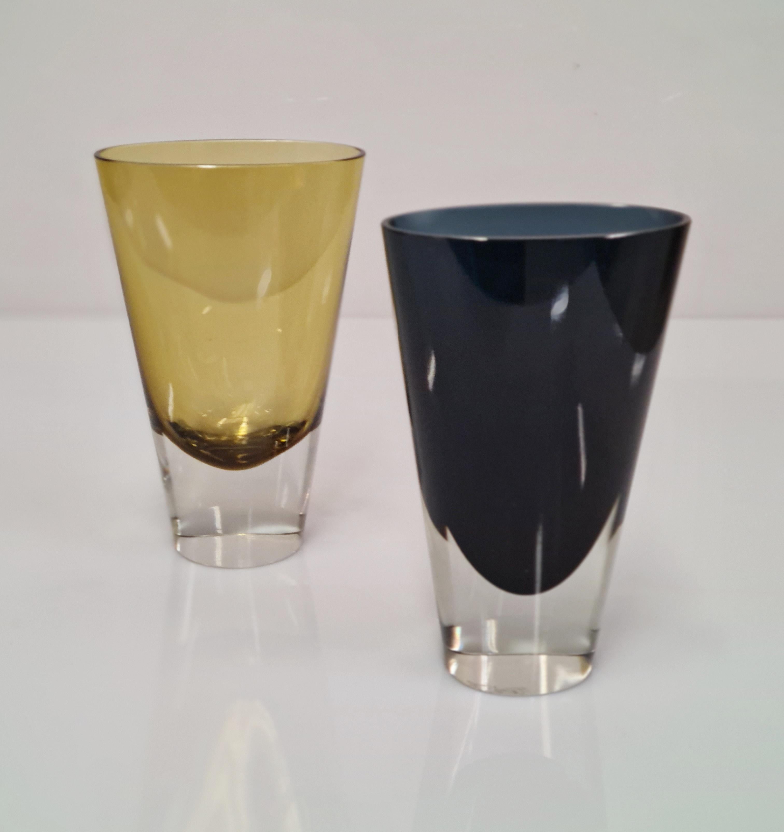 Kaj Frank (1911-1989), was a pioneer of sustainable development in the art glass area in Finland. He designed these tapered glass vases with oval rims and oval bases model KF 234 and this model was in producion during 1955-1964 period. The colors of