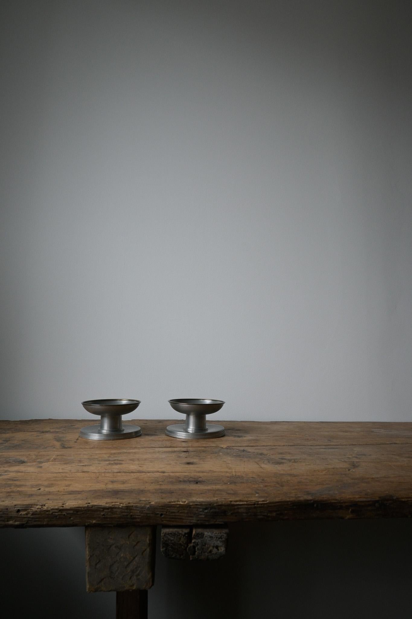 A set of two Swedish Tenn Candlestick Holders by GAB, Guldsmedsaktiebolaget ca 1930-1940

I just love the size and chunkiness of these candlestick holders, with the brass rim.

Model: 563
Stamped: Svenskt Tenn Vara GAB
Made of pewter.

Heigth: 6