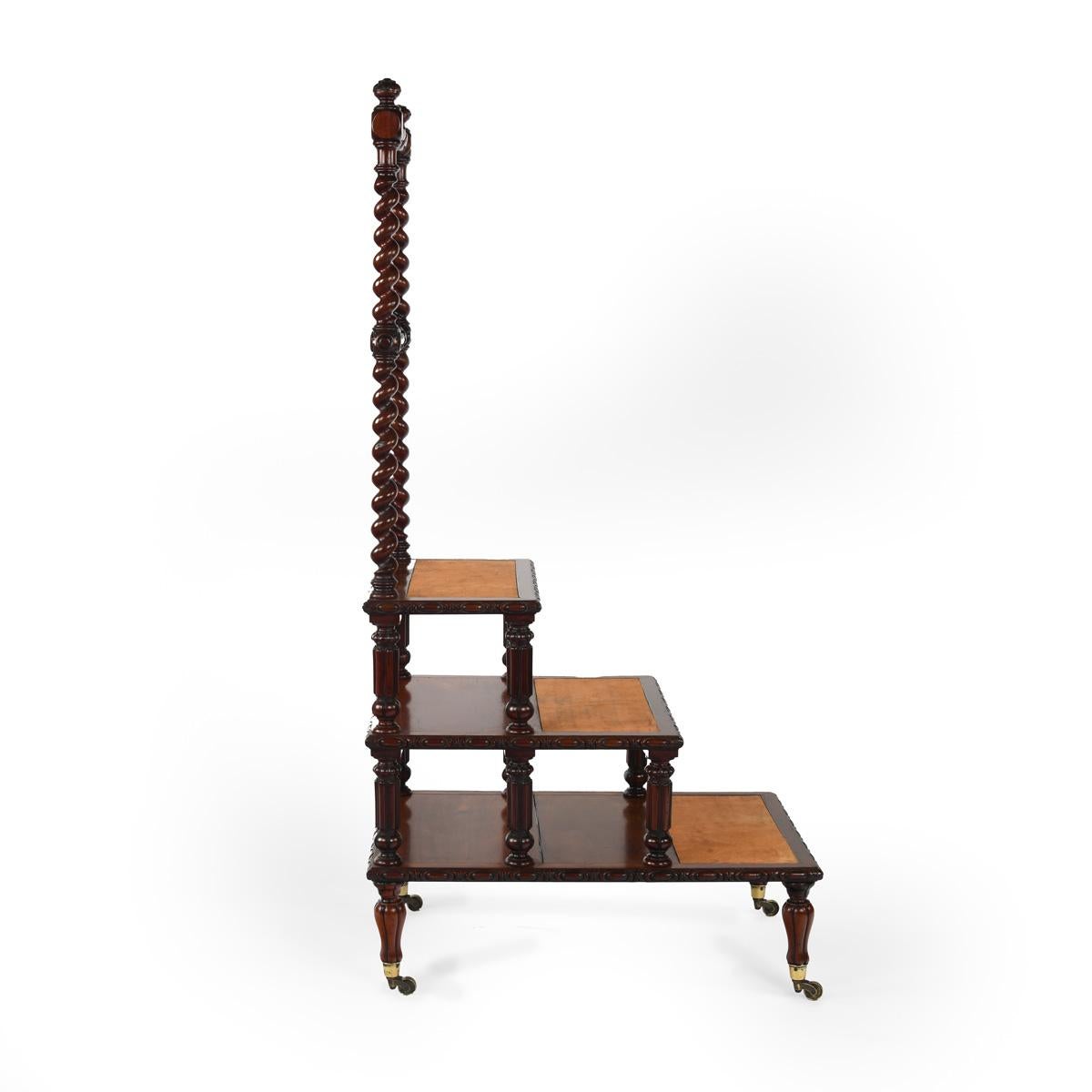 A set of Victorian mahogany library steps, of rectangular form with three steps and a barley twist frame with two baluster turned rails, the treads applied with leather insets, the top two steps raised on gadrooned column legs, the thirds step on