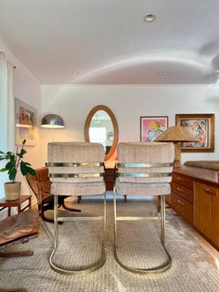 A set of vintage mid century cantilever bar stools in the style of Milo Baughman