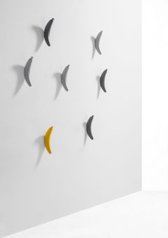 A Set of Yellow & Grey Wooden Banana Coat Hanger by Jaime Hyon