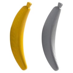 A Set of Yellow & Grey Wooden Banana Coat Hanger by Jaime Hyon