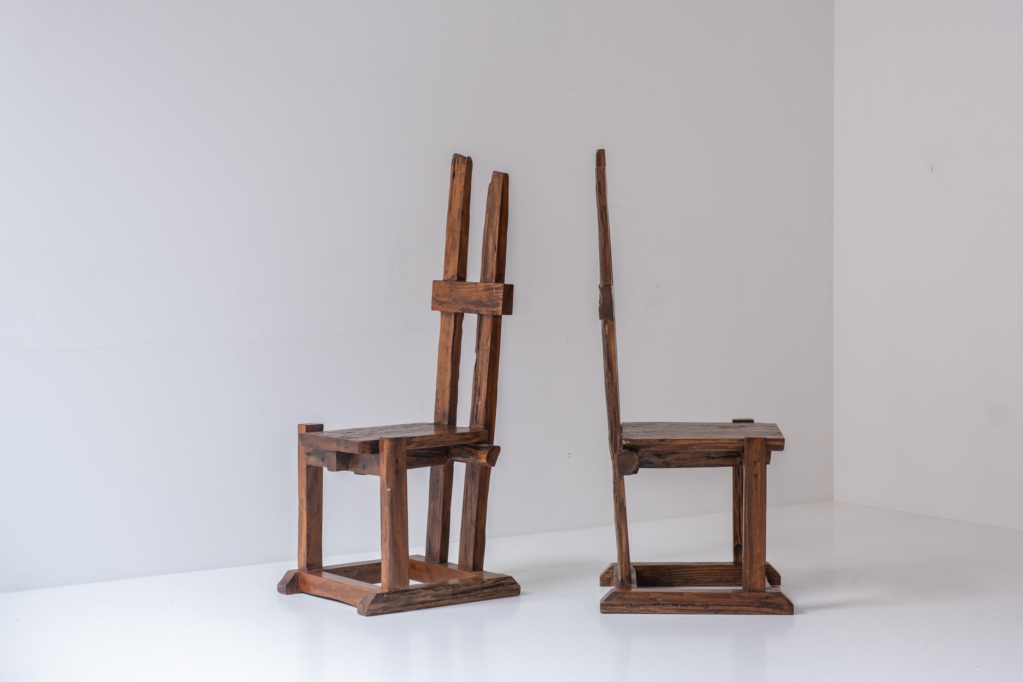 A set of two primitive high back chairs designed and manufactured during the 1950s. The craftsman was inspired by the wabi-sabi philosophy centered on the acceptance of transience and imperfection. Unique pair in its original untouched condition.
