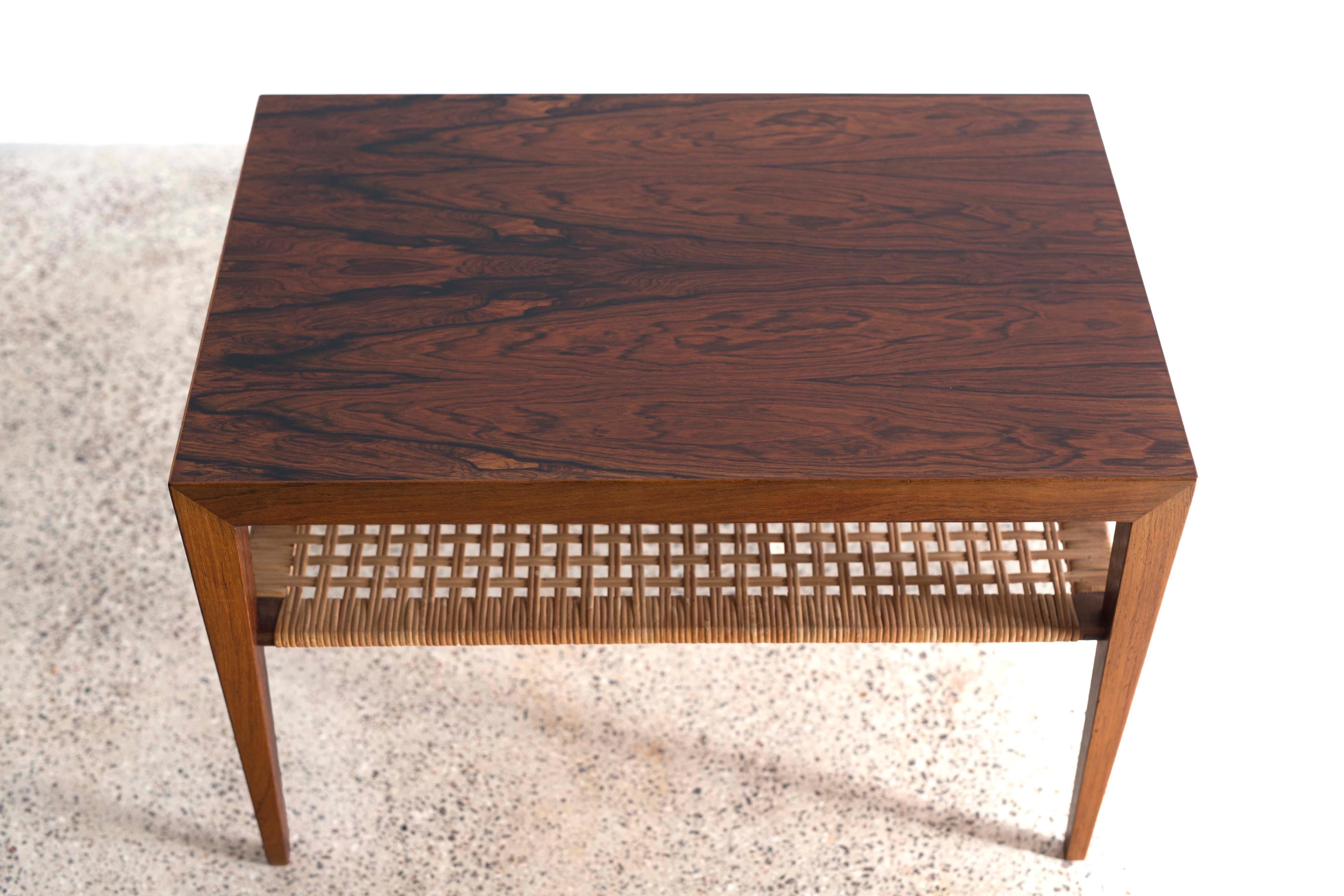 A Severin Hansen side or coffee table in Brazilian rosewood with cane shelf. 

Designed by Severin Hansen 1960s and made at Haslev møbelsnedkeri in Denmark.