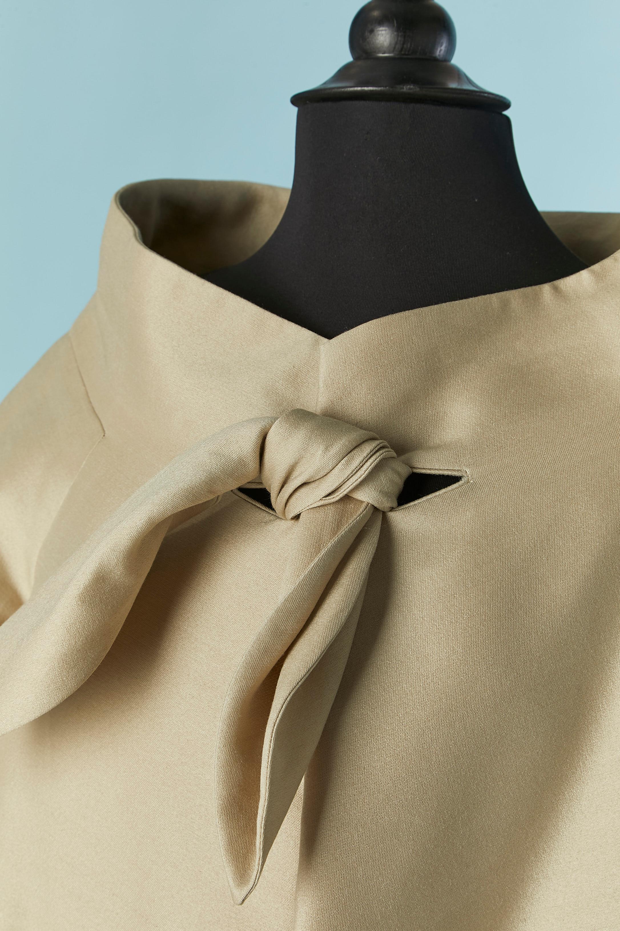 Coat made for the shop ADRIAN  in Boston . 
 A shape beige coat with bow on the top middle front. No fabric composition tag but probably silk and rayon with lining in the same fabric . 
Pocket on both side. 
SIZE L