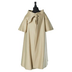 A shape beige coat with bow on the top middle front ADRIAN / PAULINE TRIGERE