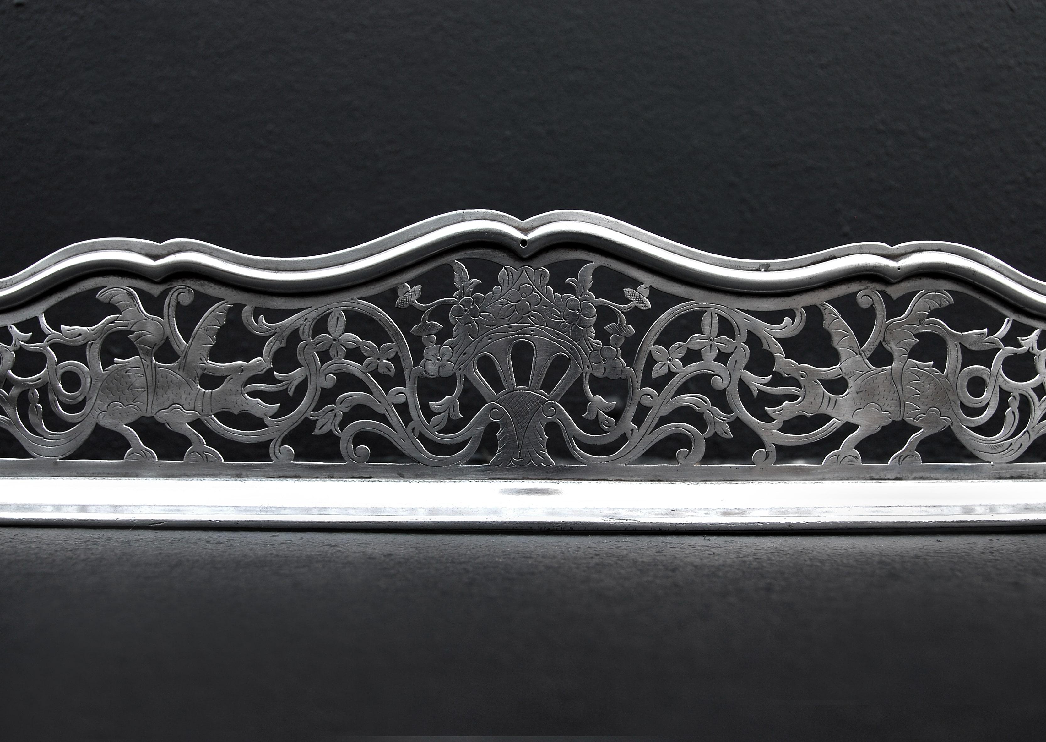 An attractive English bowed steel fender. The engraved pierced fret featuring foliage and dragons, with shaped moulding above.

External Width:	1175 mm      	46 ¼