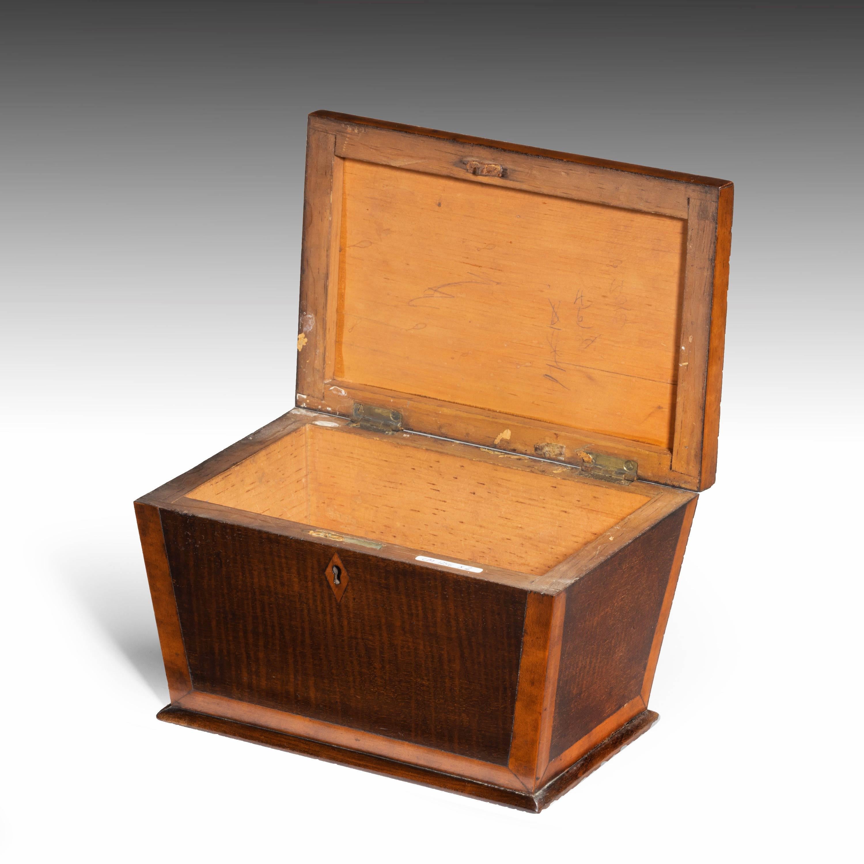 A shaped, late George III period mahogany tea caddy. The edges banded in contrasting timber. The interior now without fittings.