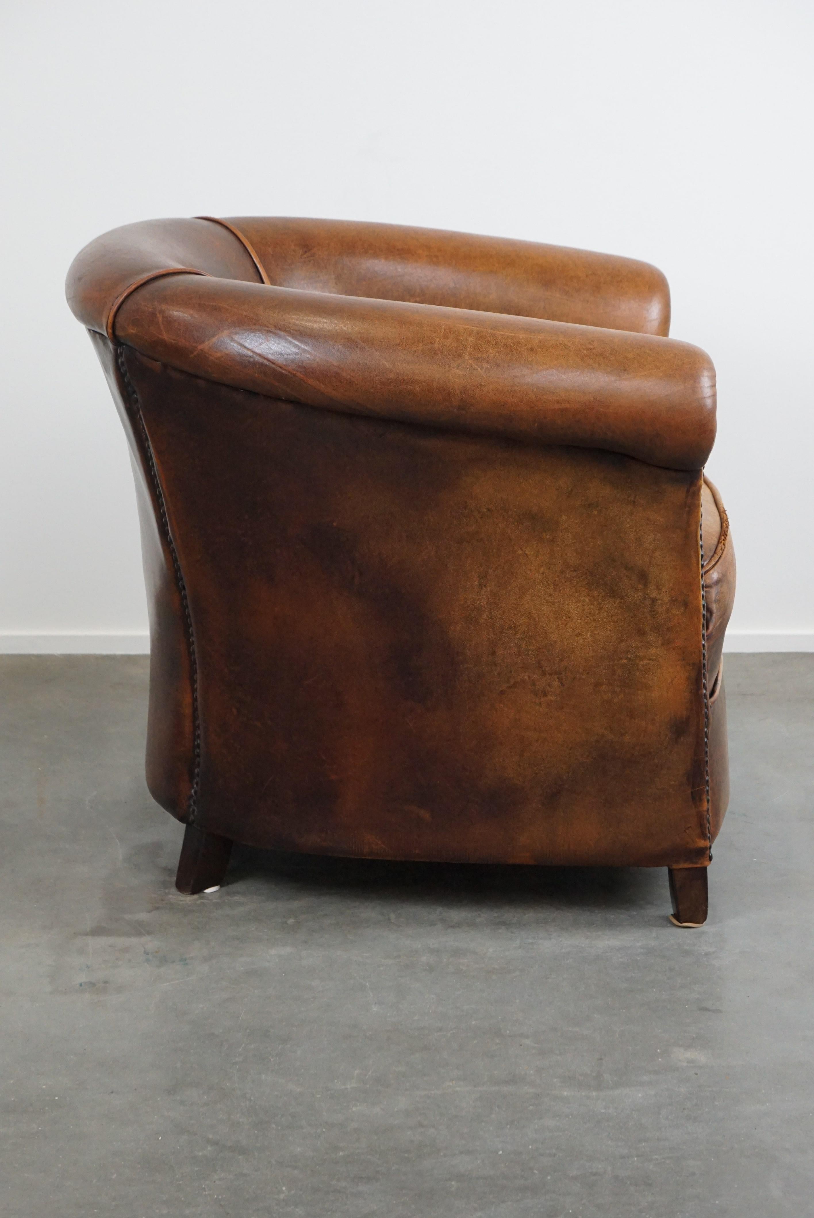 Dutch A sheep leather club armchair in good condition, modest in size. For Sale