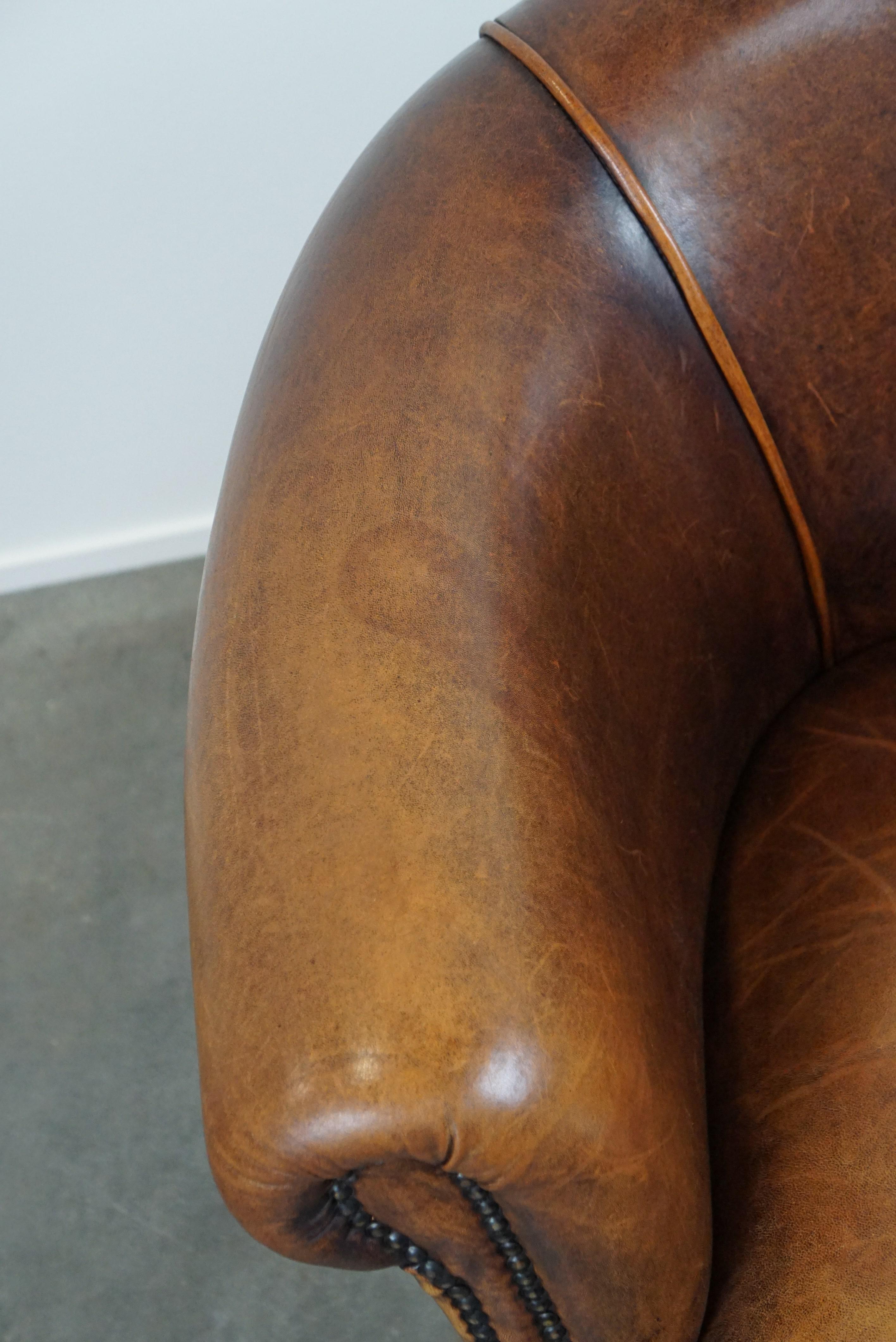 Leather A sheep leather club armchair in good condition, modest in size. For Sale