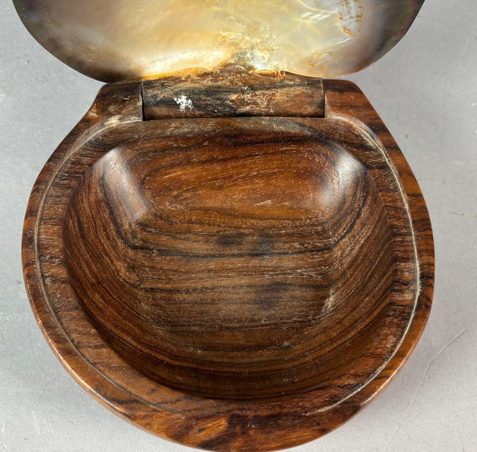 Hand-carved wooden box, attributed to Alexandre Noll, France, 1950s. Made from high-quality dark wood, it features sleek, organic lines. Its unique lid is a genuine polished shell, revealing the iridescent shine of mother-of-pearl.