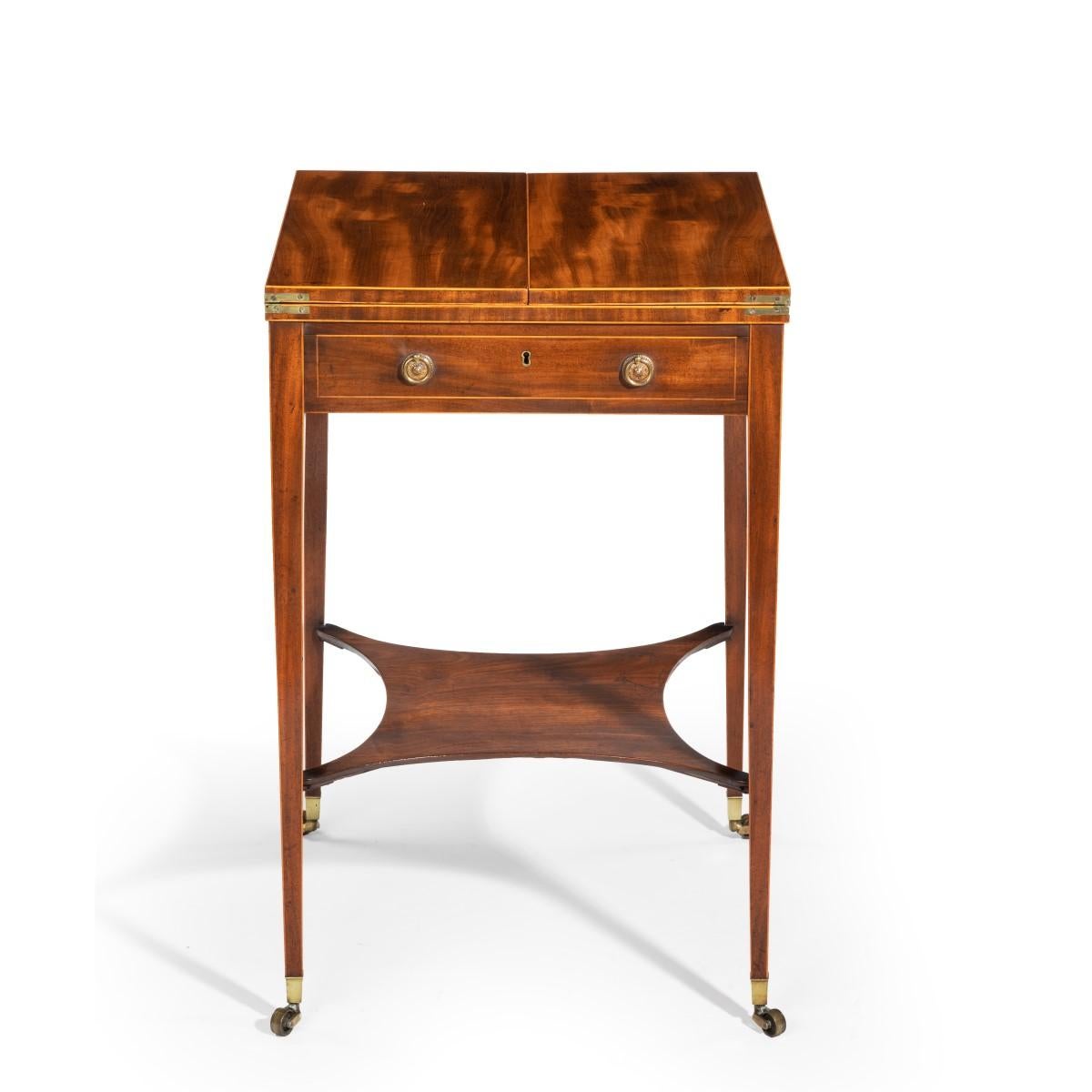 A Sheraton period George III mahogany patience table, the rectangular top with a drawer front with brass handles on each side, two hinged to support two flaps which open to form a rectangular top, set on slender tapering legs joined by a shaped