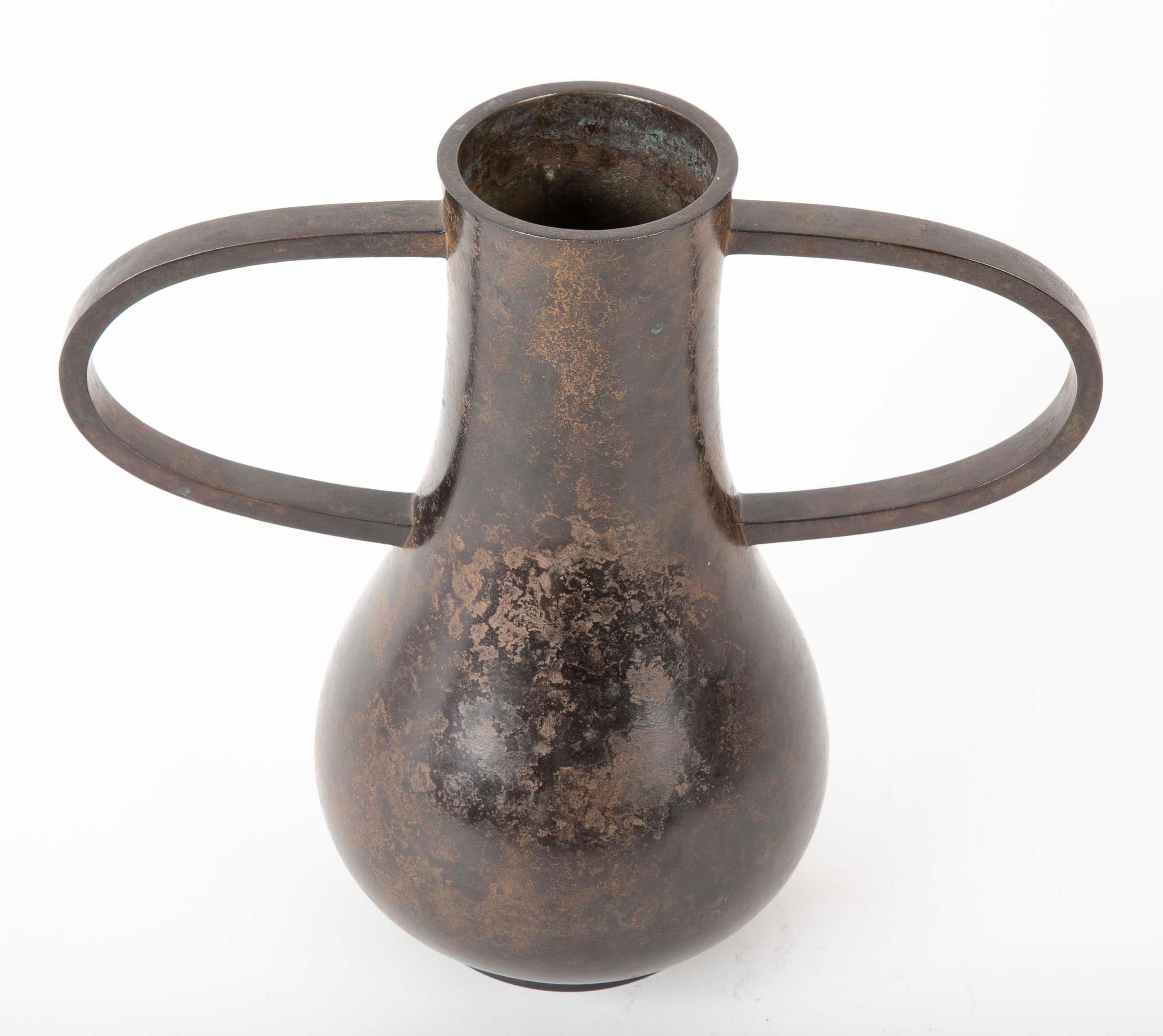 A Showa period Japanese bronze Ikebana vase with chocolate brown patina.