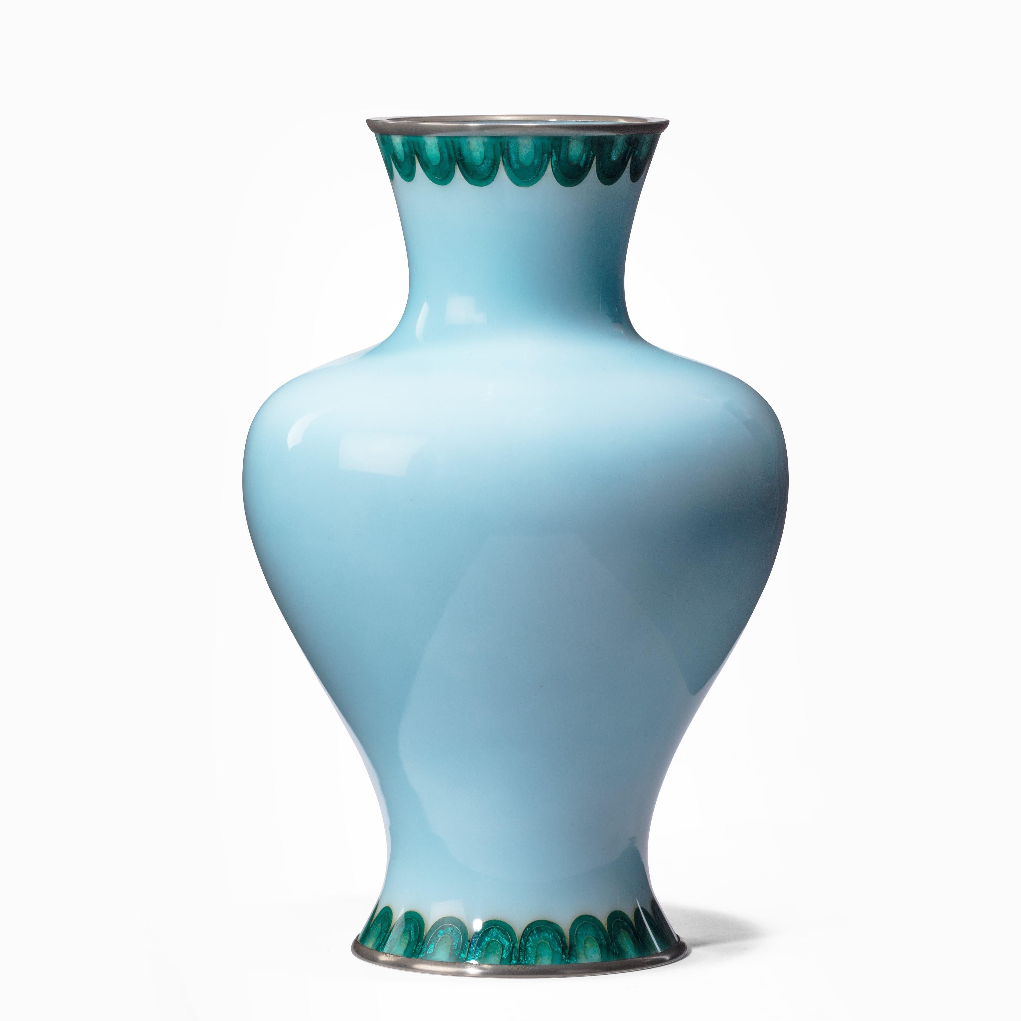 A Showa period pale blue cloisonné vase by Tamura, decorated with a central floral motif of stylized green leaves centred on a turquoise flower with a silver foil gin-bari centre, with similar gin-bari collars of petals round the rim and foot, the